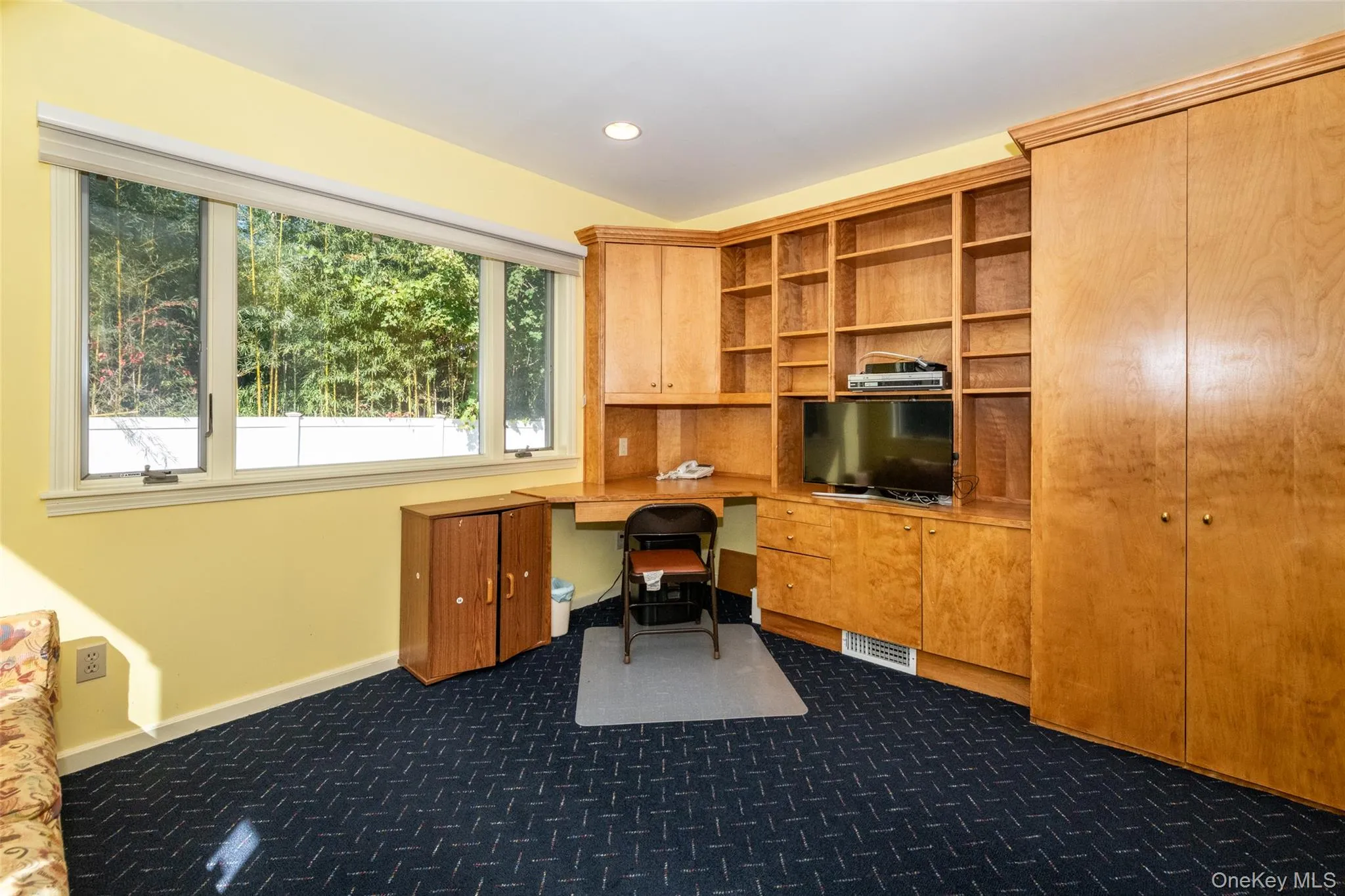 Office with built in study area, recessed lighting, and dark carpet Office with built in study area, recessed lighting, and dark carpet