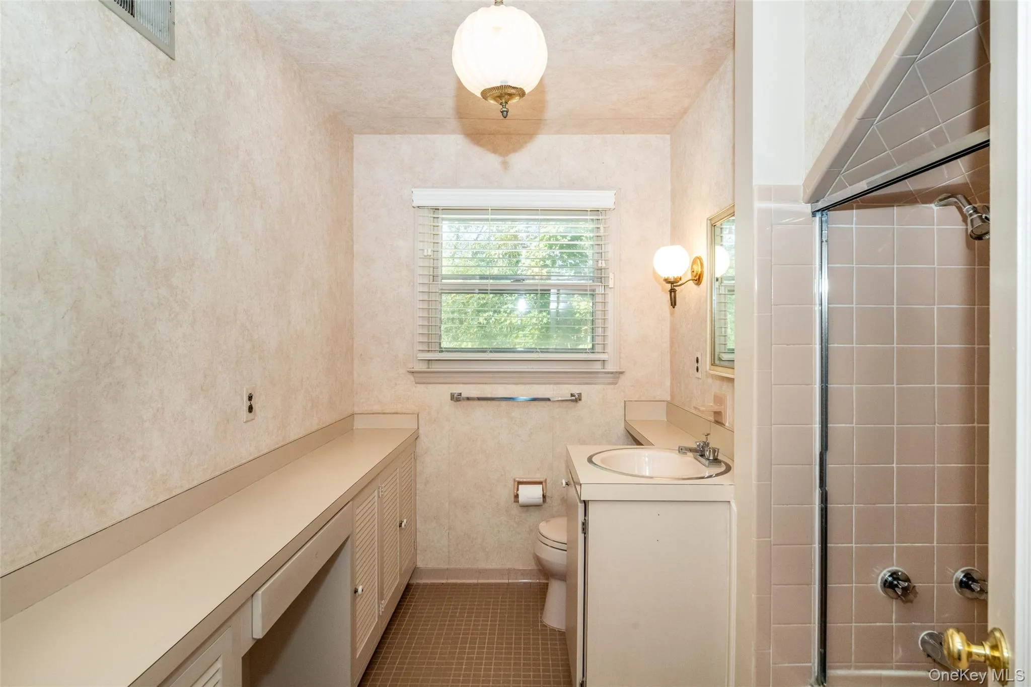 Bathroom with vanity, shower / washtub combination, and dark tile patterned flooring Bathroom with vanity, shower / washtub combination, and dark tile patterned flooring
