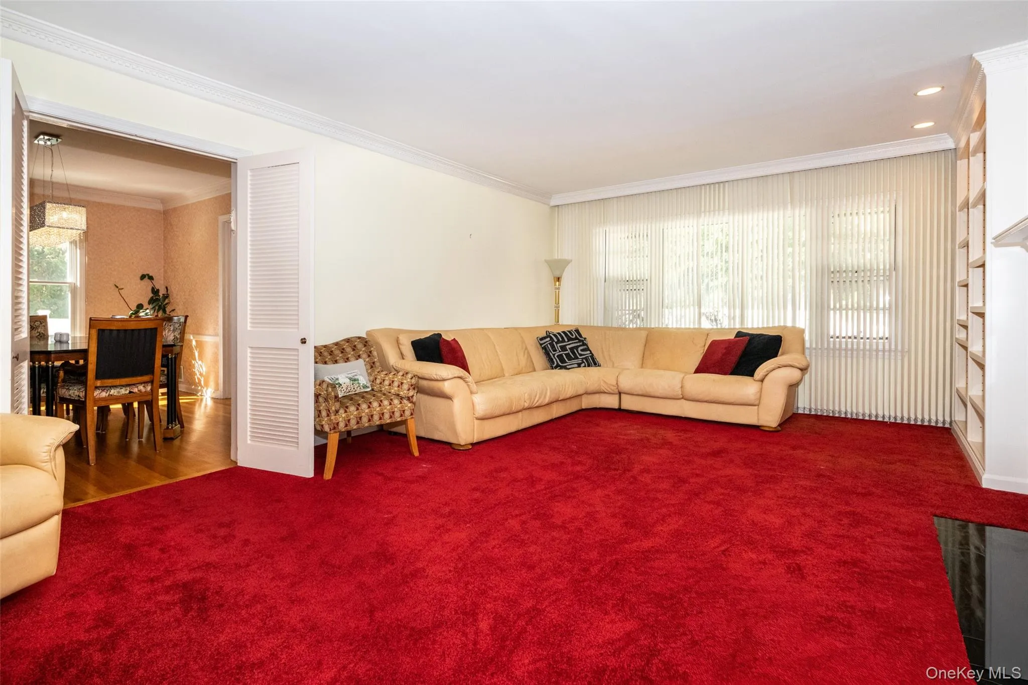 Living area with ornamental molding and carpet floors Living area with ornamental molding and carpet floors