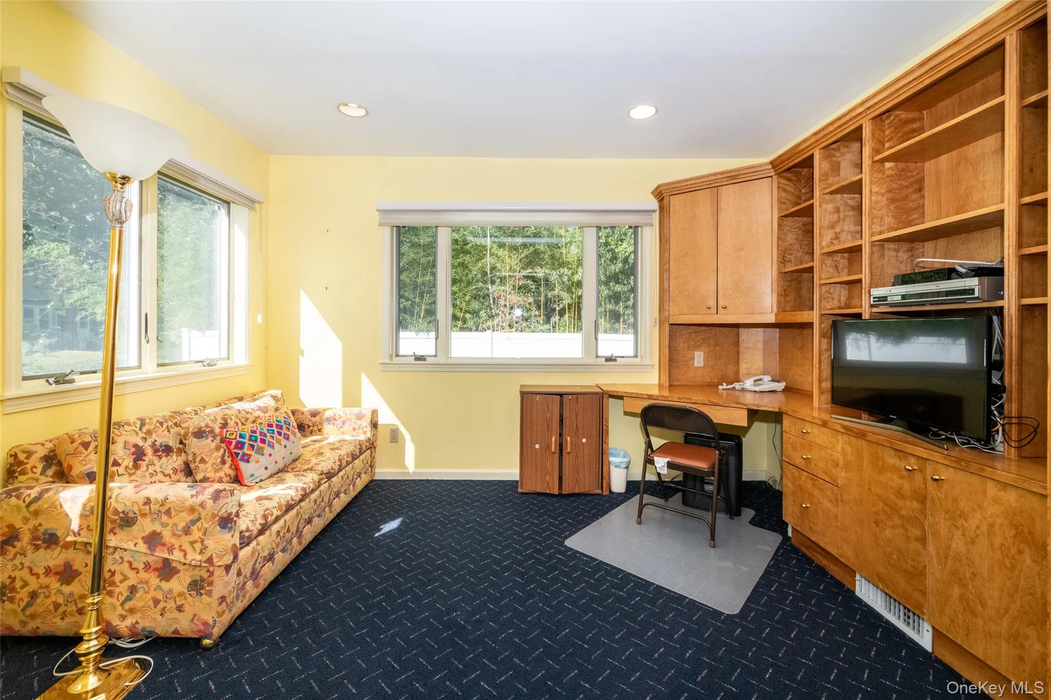 Office space featuring built in study area, dark colored carpet, and recessed lighting Office space featuring built in study area, dark colored carpet, and recessed lighting