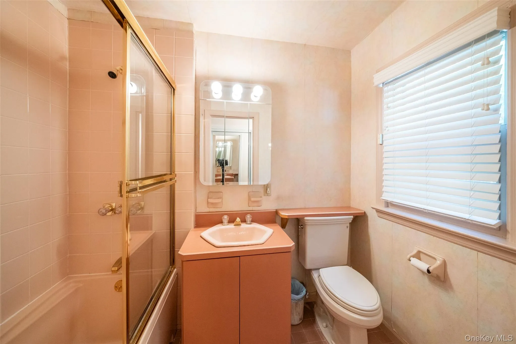 Bathroom featuring enclosed tub / shower combo, vanity, and tile patterned floors Bathroom featuring enclosed tub / shower combo, vanity, and tile patterned floors