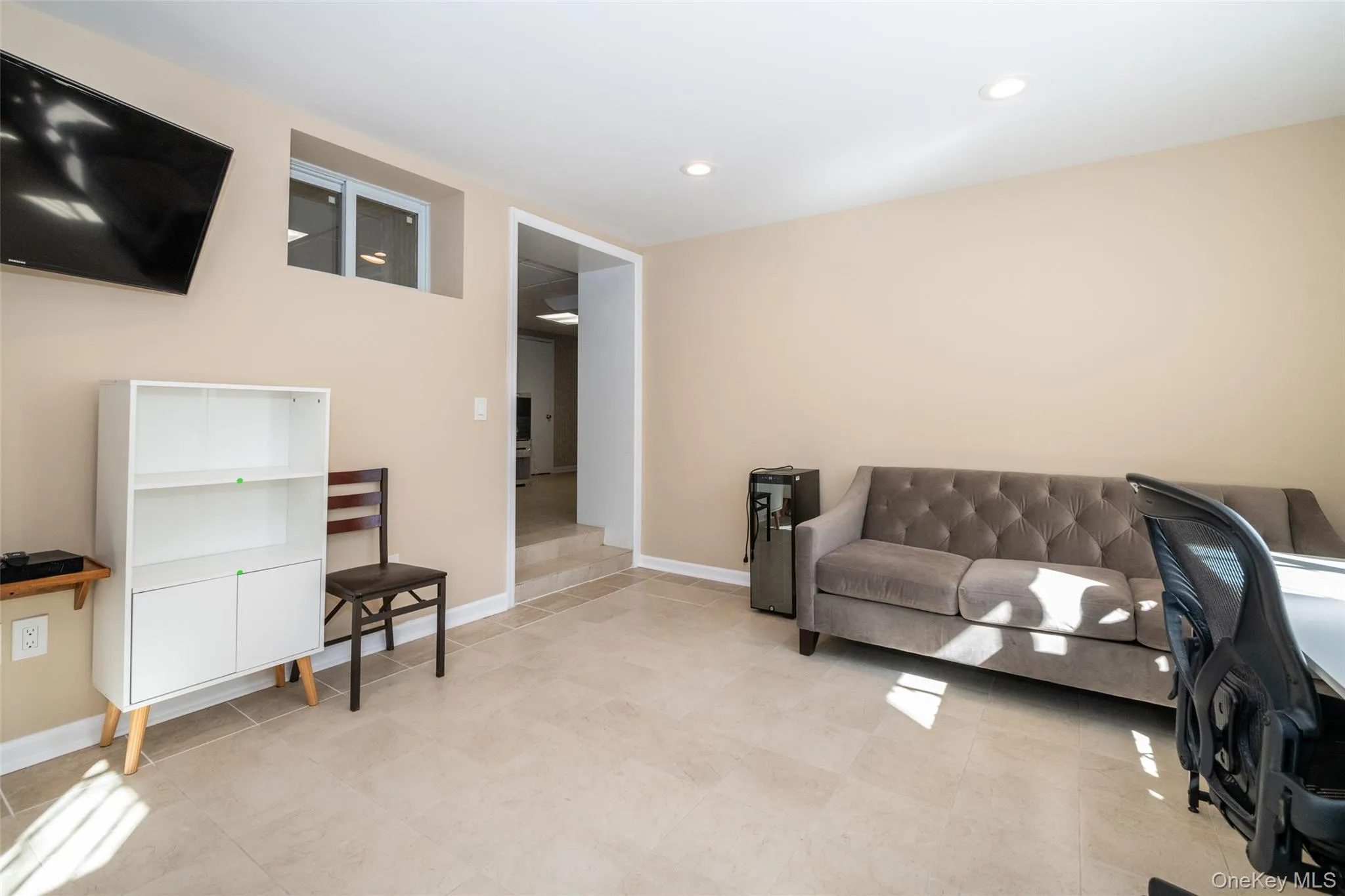 Living room with recessed lighting and light tile patterned floors Living room with recessed lighting and light tile patterned floors