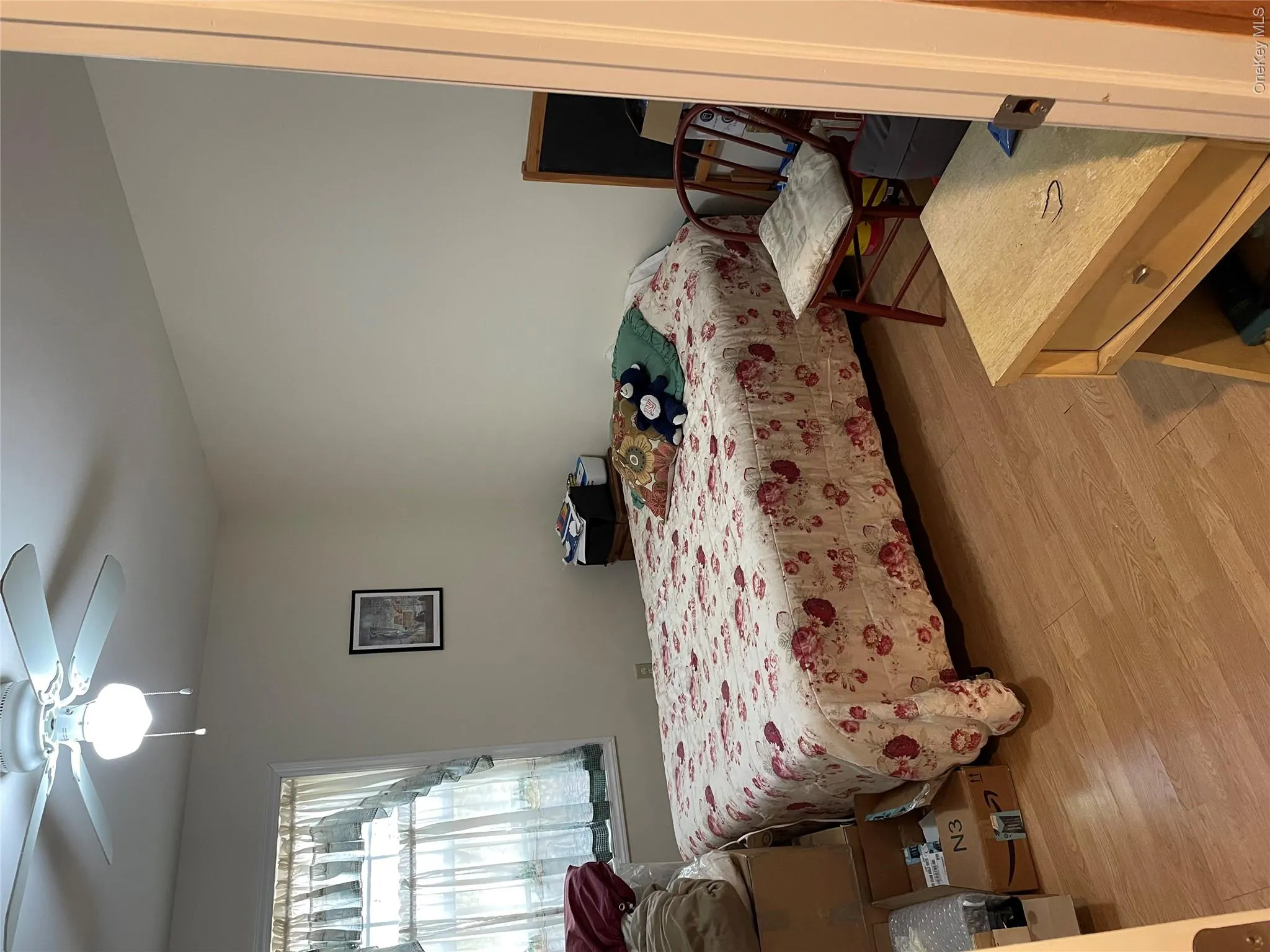 Bedroom with light wood-style floors and ceiling fan Bedroom with light wood-style floors and ceiling fan