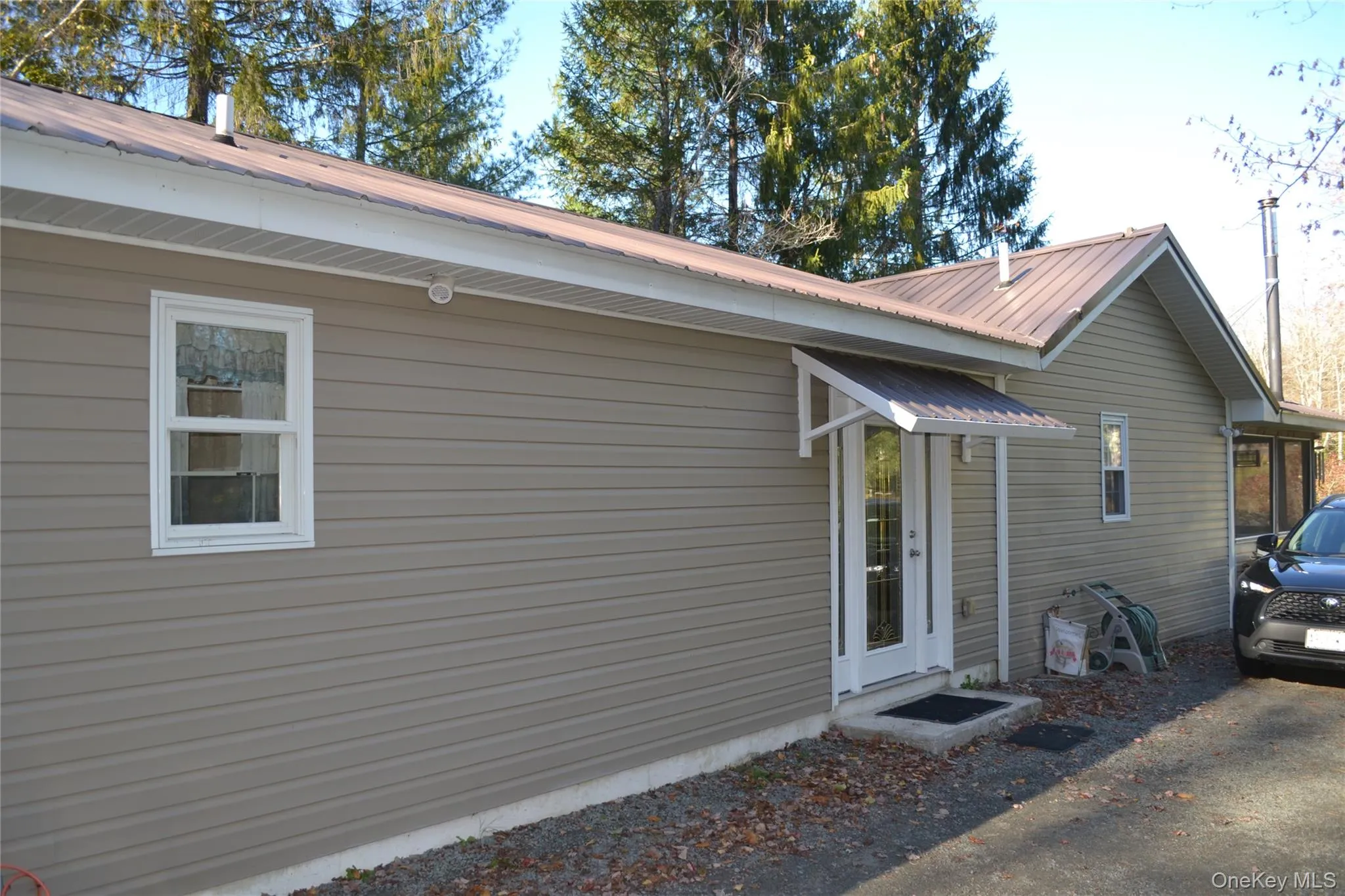 View of home's exterior featuring a metal roof View of home's exterior featuring a metal roof