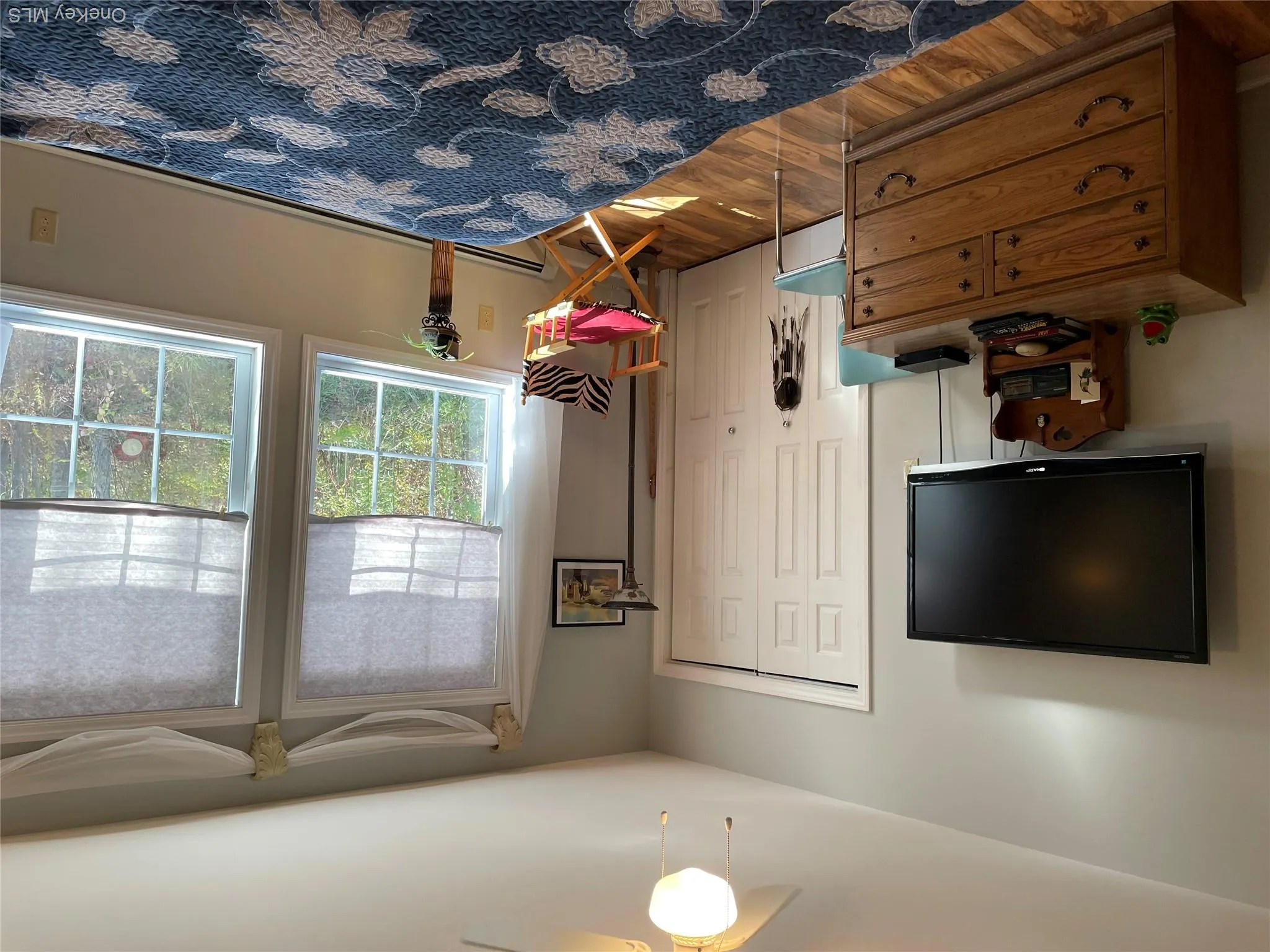 Bedroom featuring light wood-type flooring, a ceiling fan, a closet, and a baseboard radiator Bedroom featuring light wood-type flooring, a ceiling fan, a closet, and a baseboard radiator