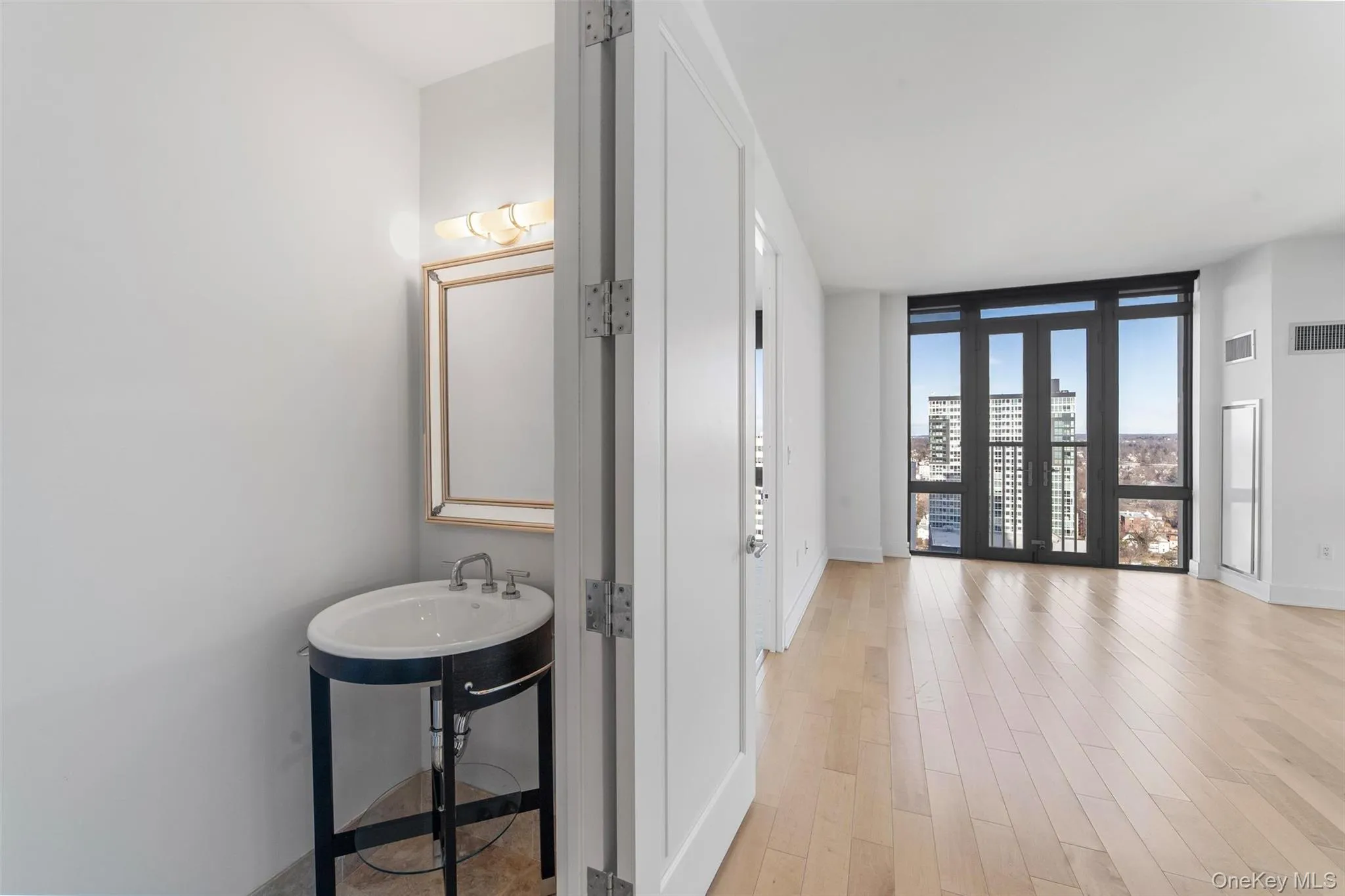 Hallway with a wall of windows, light wood-type flooring, and a city view Hallway with a wall of windows, light wood-type flooring, and a city view