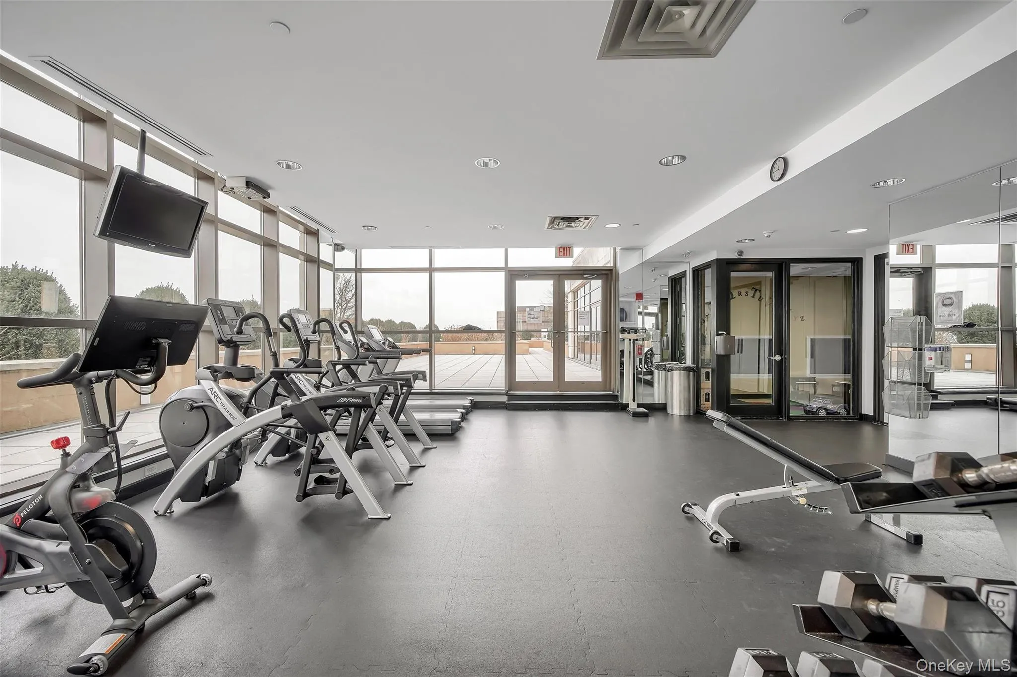 Workout area with floor to ceiling windows and recessed lighting Workout area with floor to ceiling windows and recessed lighting