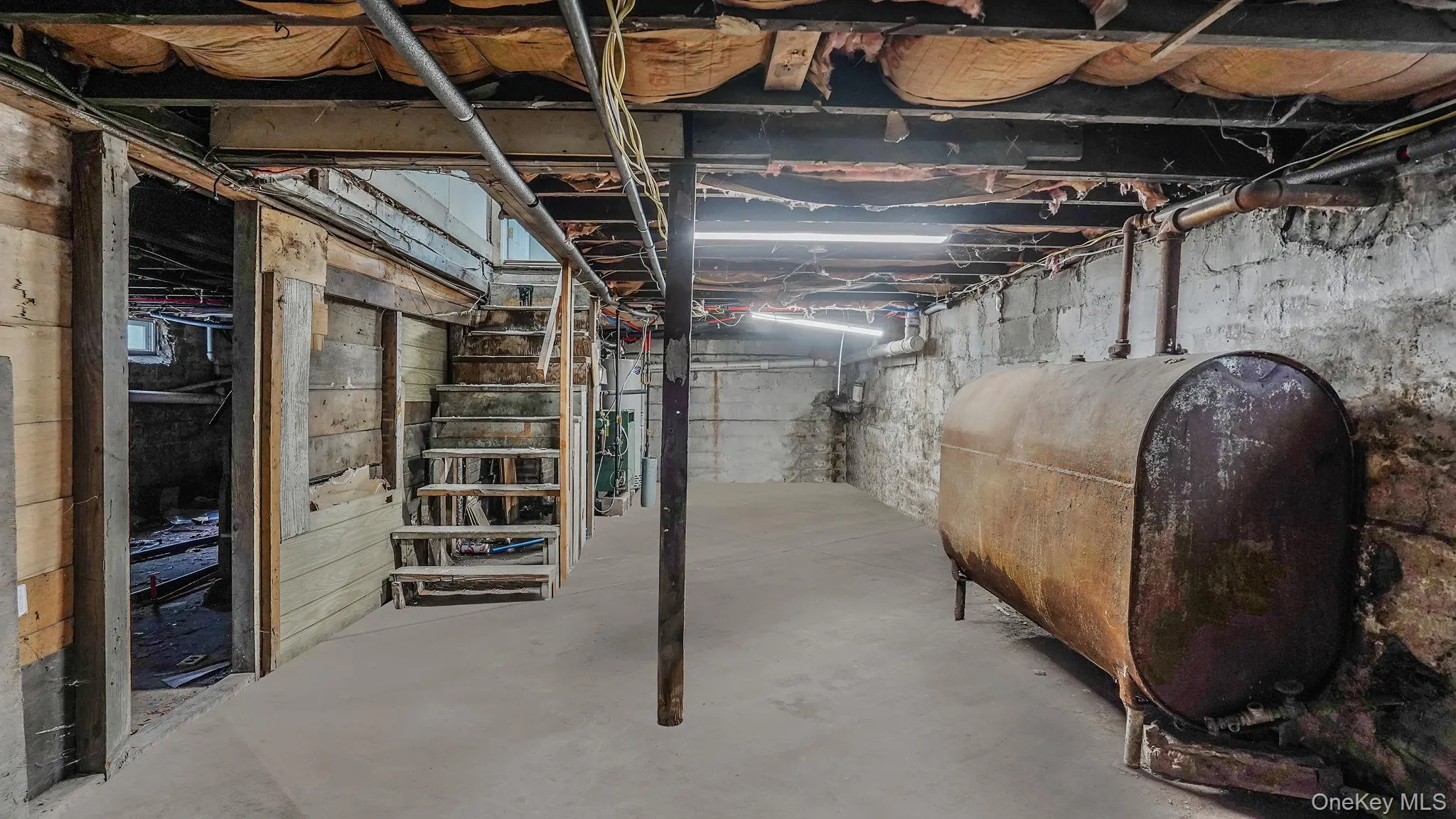 Unfinished below grade area with oil tank Unfinished below grade area with oil tank