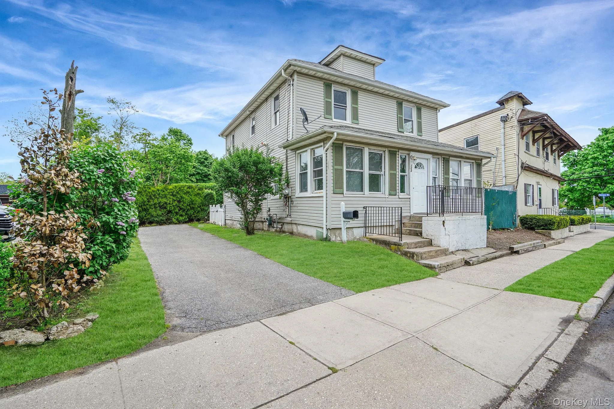 Traditional style home with asphalt driveway Traditional style home with asphalt driveway