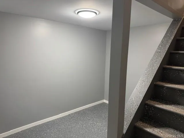 Stairway featuring baseboards Stairway featuring baseboards