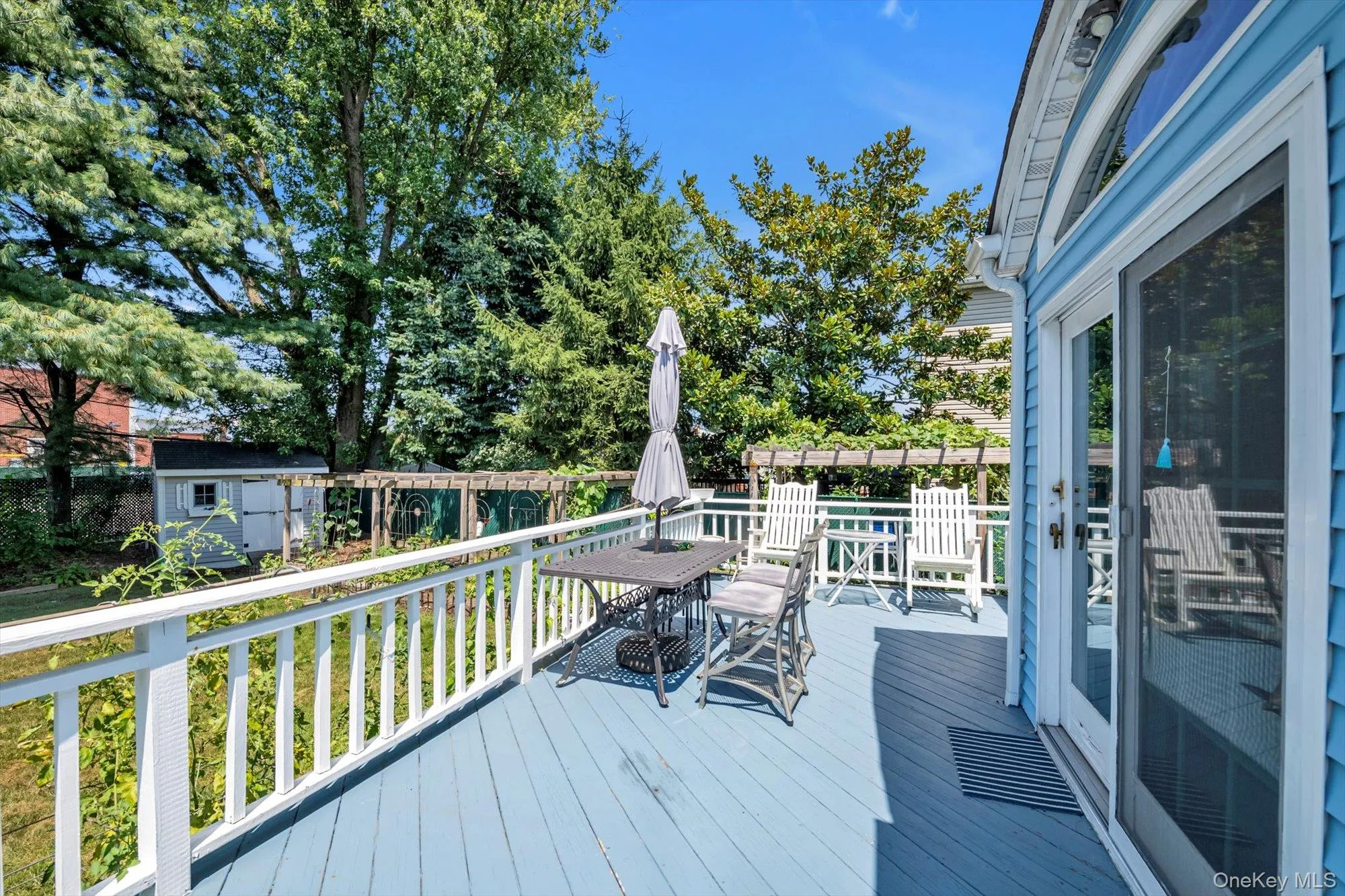 Wooden deck featuring outdoor dining area and a shed Wooden deck featuring outdoor dining area and a shed