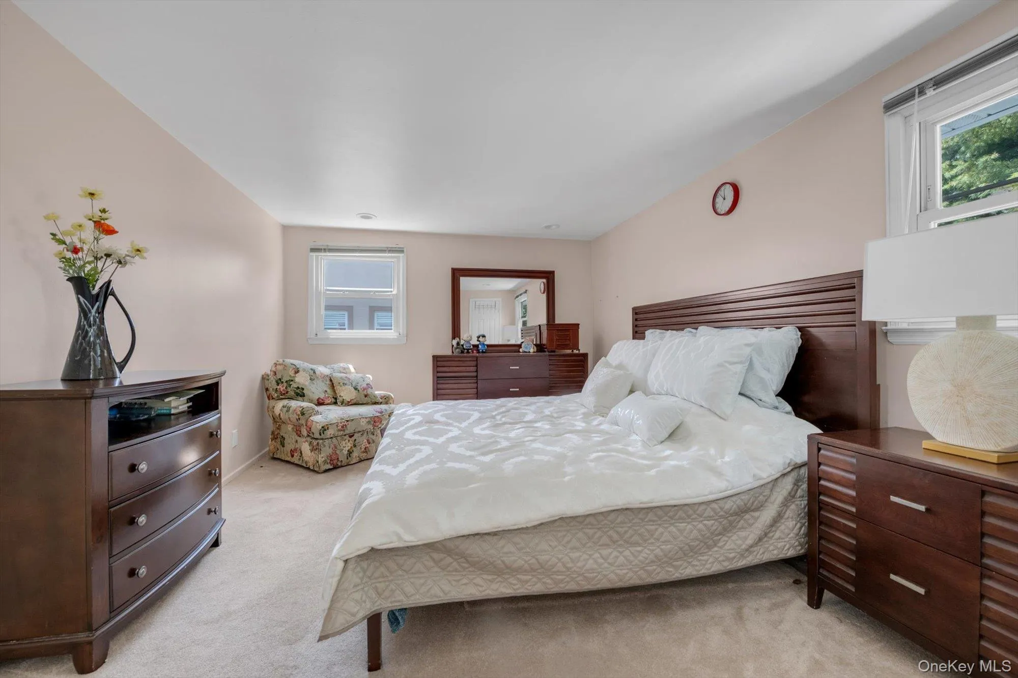 Bedroom featuring light carpet and baseboards Bedroom featuring light carpet and baseboards