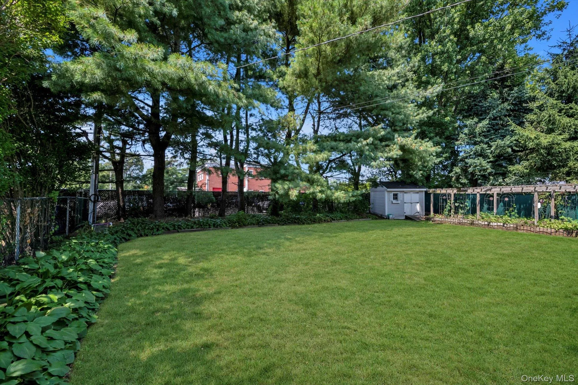 Fenced backyard with a storage unit Fenced backyard with a storage unit