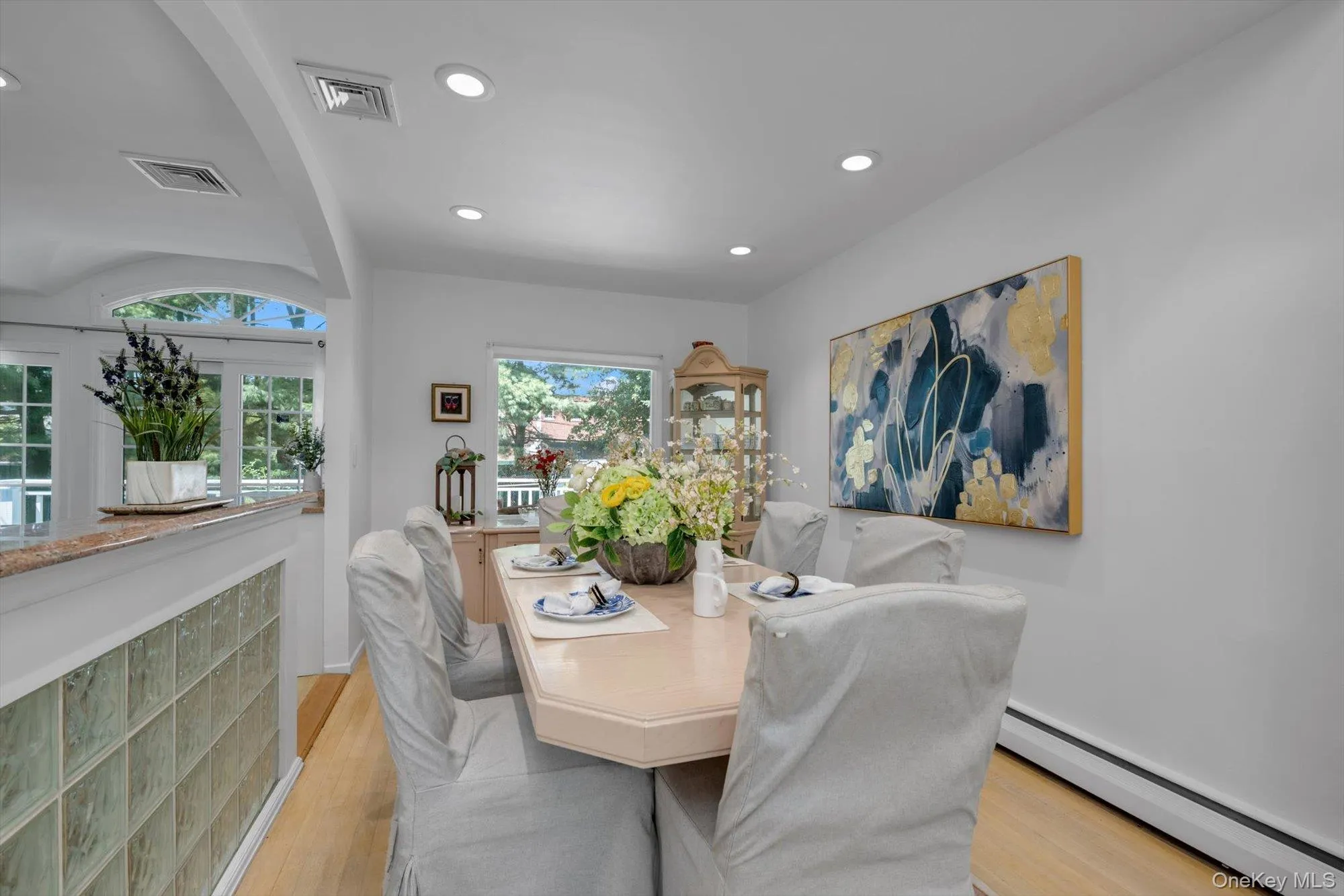 Dining room featuring baseboard heating, recessed lighting, and light wood-type flooring Dining room featuring baseboard heating, recessed lighting, and light wood-type flooring