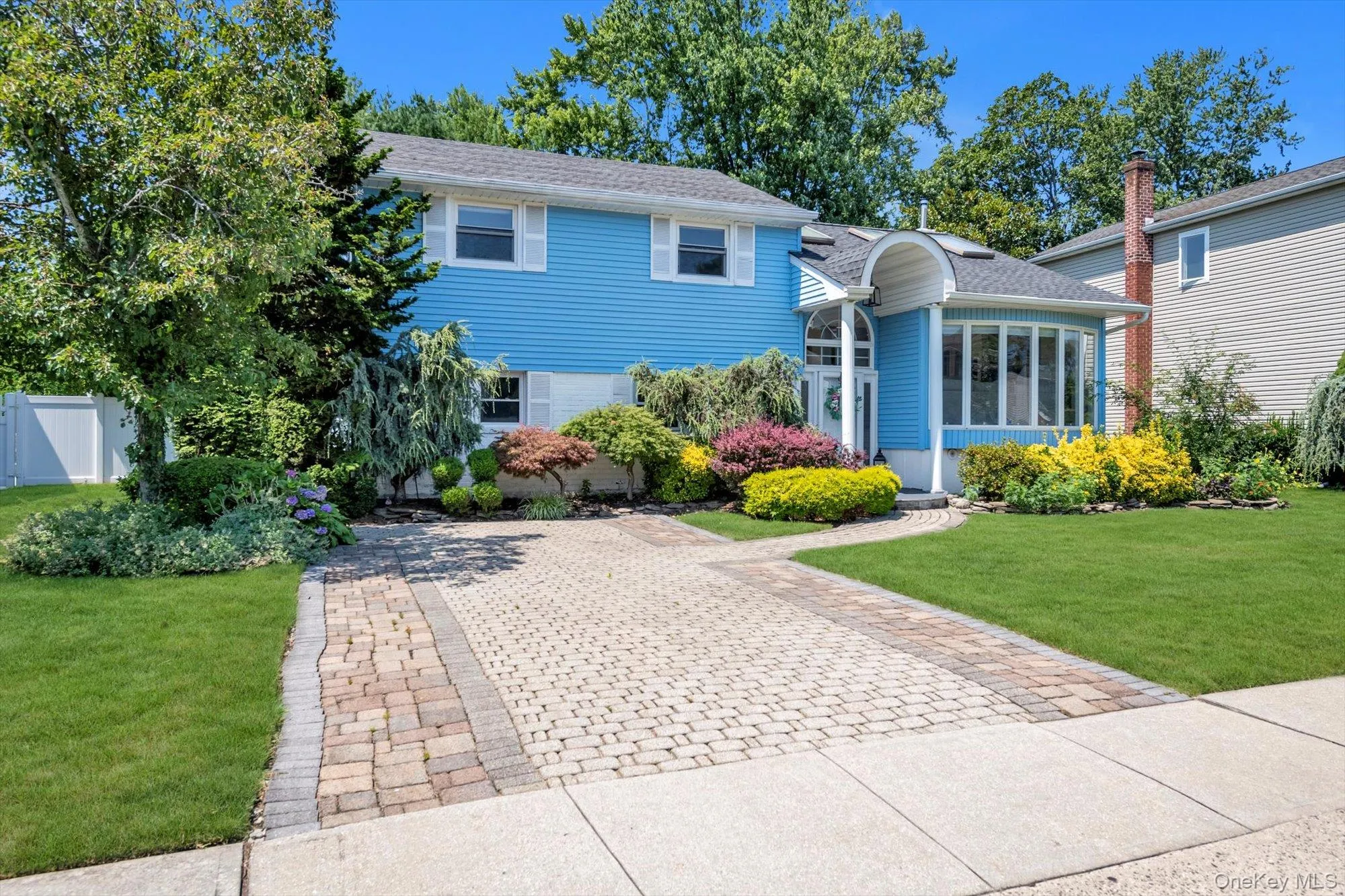 Split level home with roof with shingles and a sunroom Split level home with roof with shingles and a sunroom