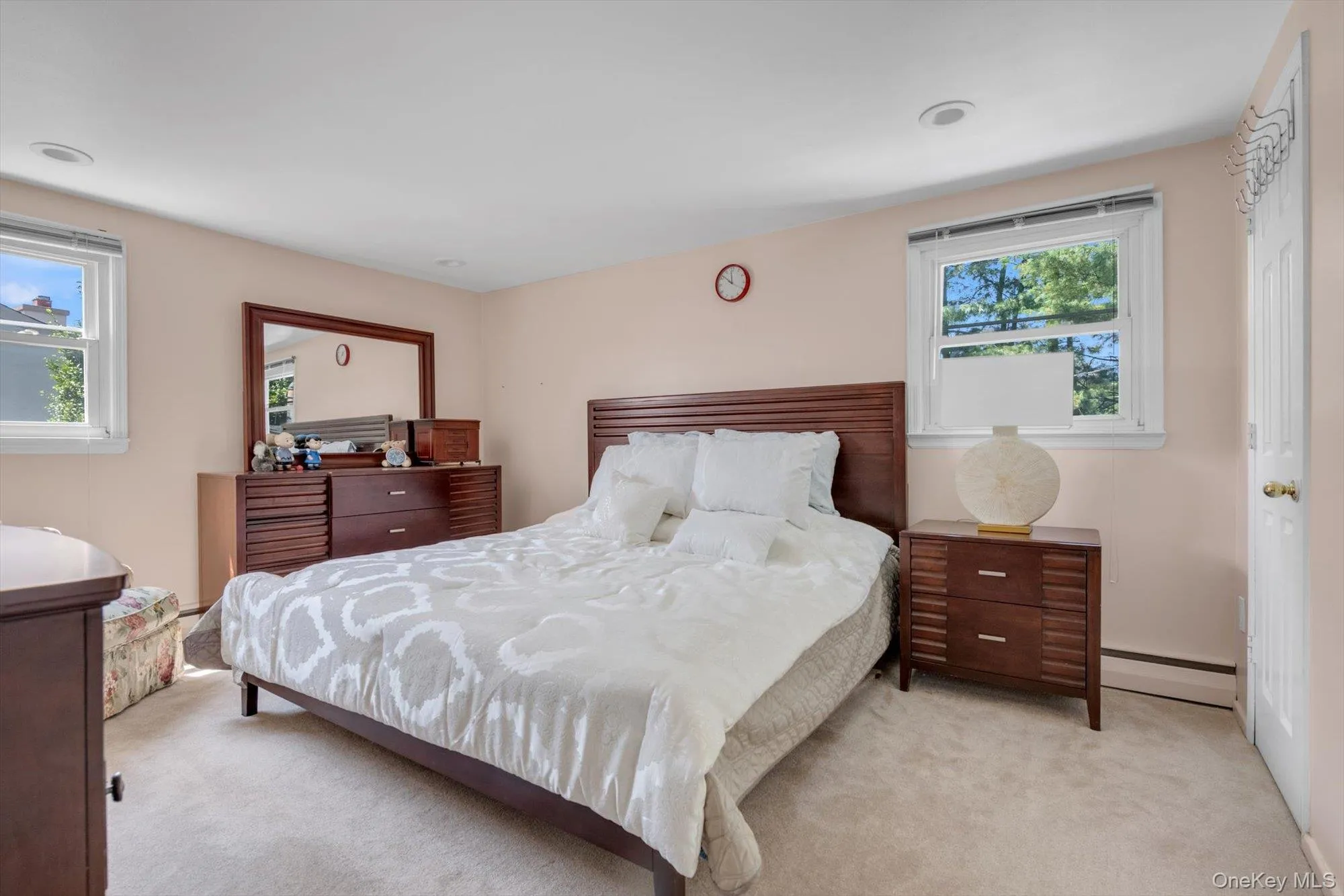 Carpeted bedroom with a baseboard radiator Carpeted bedroom with a baseboard radiator
