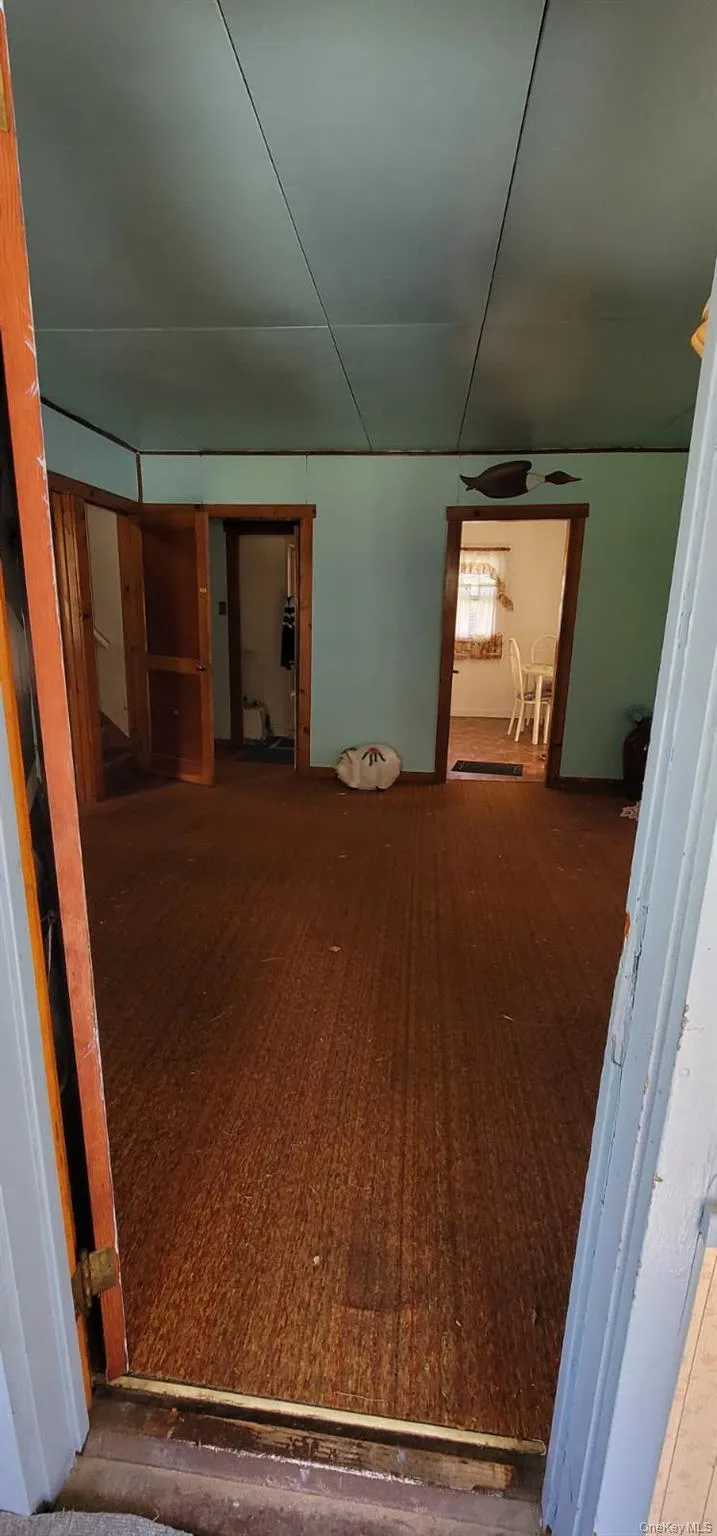 Corridor with hardwood / wood-style flooring Corridor with hardwood / wood-style flooring