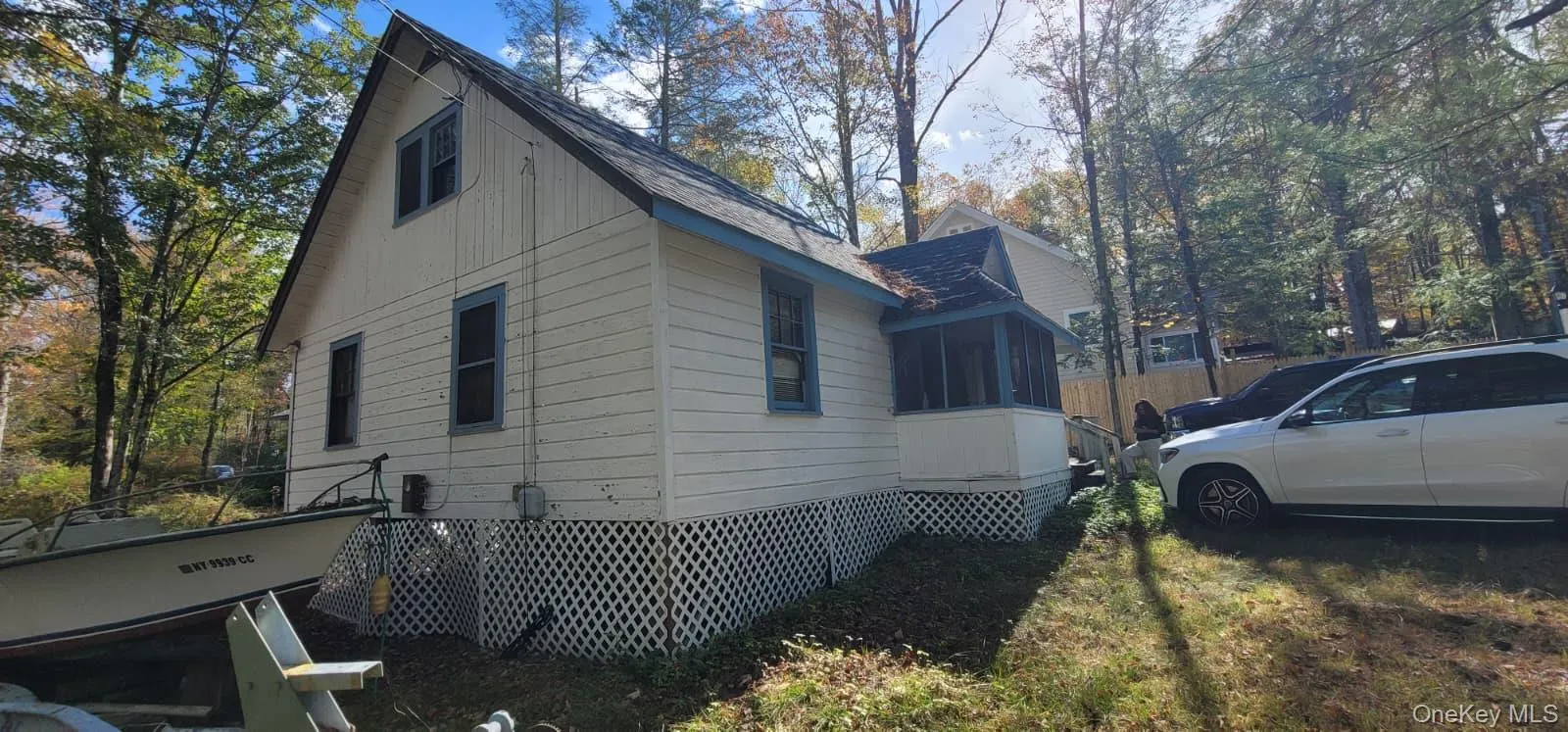 View of side of home featuring a sunroom and roof with shingles View of side of home featuring a sunroom and roof with shingles