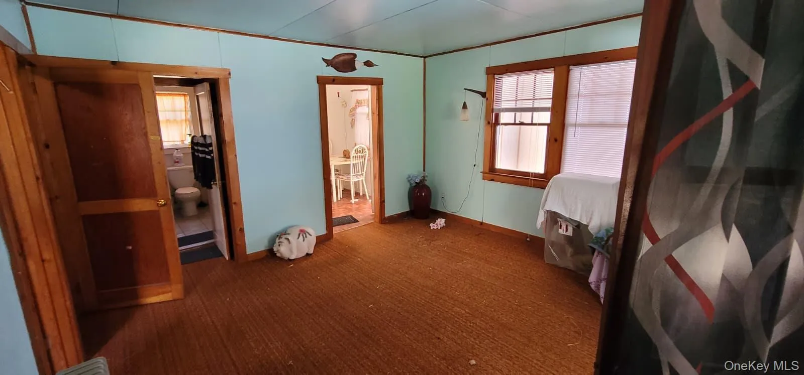 Unfurnished bedroom with ensuite bath, dark carpet, and crown molding Unfurnished bedroom with ensuite bath, dark carpet, and crown molding