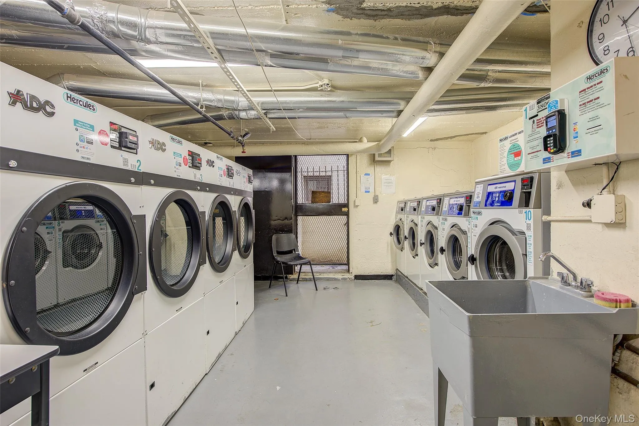 Communal laundry room with washer and clothes dryer Communal laundry room with washer and clothes dryer