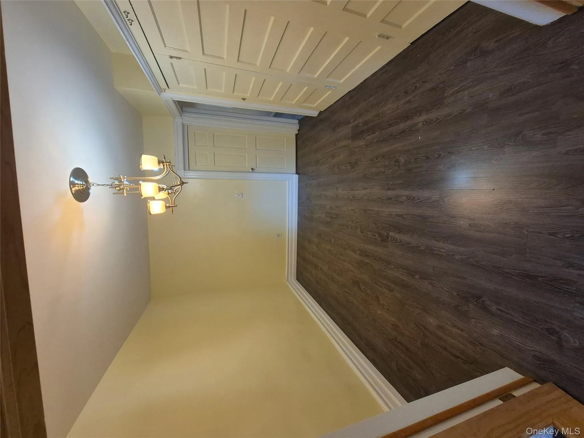 Unfurnished dining area featuring dark wood-style floors and a chandelier Unfurnished dining area featuring dark wood-style floors and a chandelier