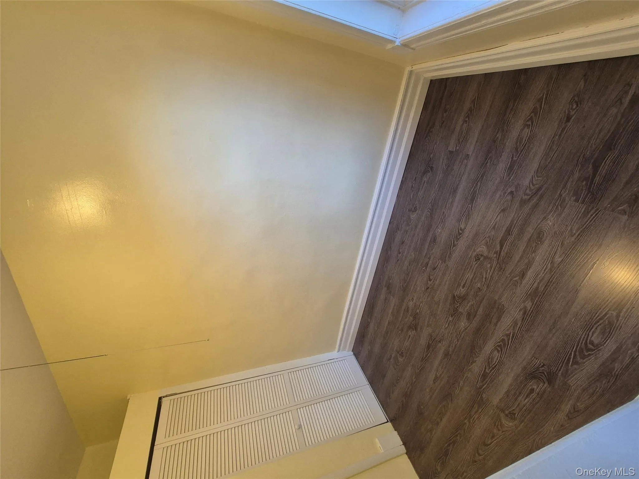 Unfurnished dining area with dark wood-style flooring and baseboards Unfurnished dining area with dark wood-style flooring and baseboards