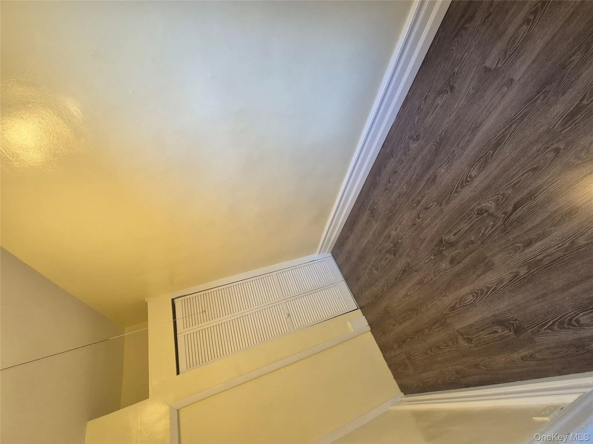 Unfurnished bedroom with wood finished floors and a closet Unfurnished bedroom with wood finished floors and a closet