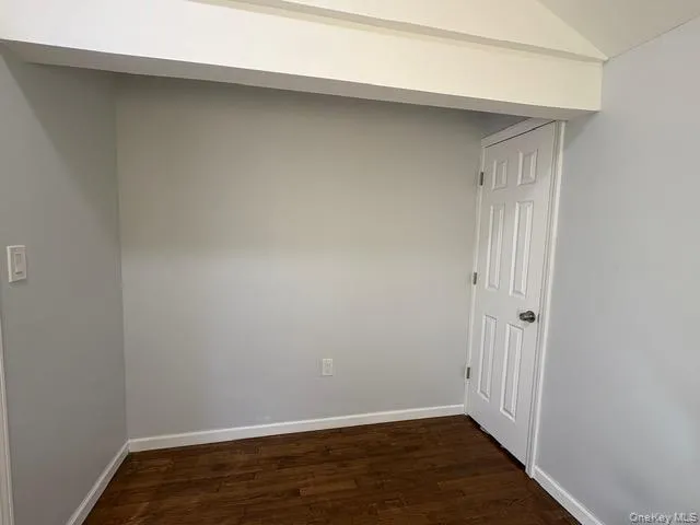 Bedroom room featuring dark wood-type flooring and lofted ceiling Bedroom room featuring dark wood-type flooring and lofted ceiling