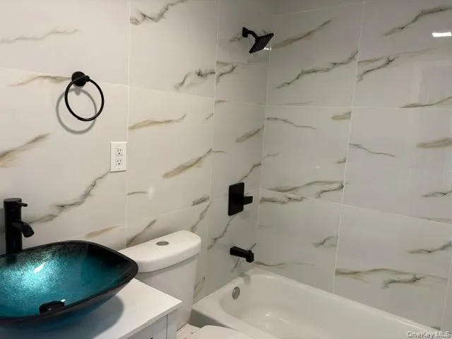 Full bathroom featuring shower / bath combination and vanity Full bathroom featuring shower / bath combination and vanity