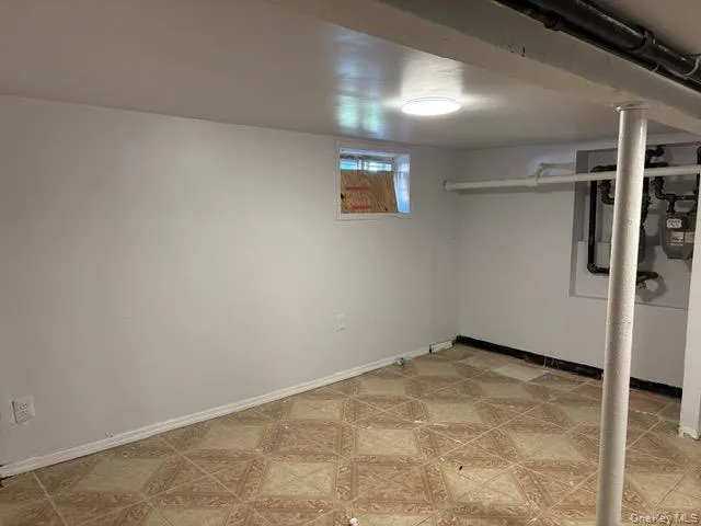 Basement featuring baseboards and gas meter Basement featuring baseboards and gas meter