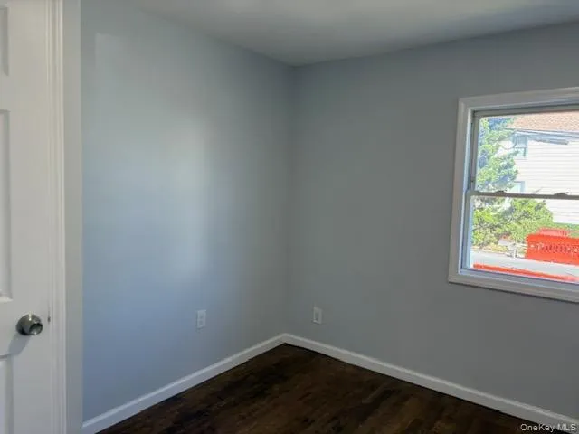 Bedroom with baseboards and dark wood finished floors Bedroom with baseboards and dark wood finished floors