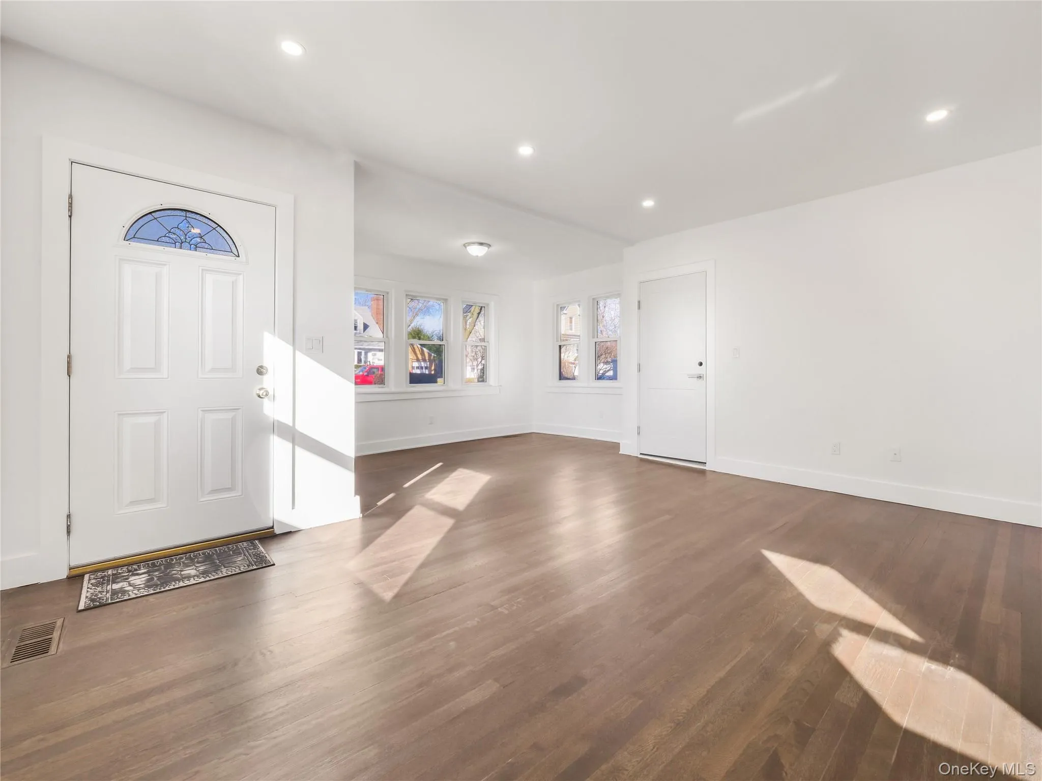 Entryway featuring dark hardwood / wood-style flooring. There are 2 entrydoors to Unit 1 Entryway featuring dark hardwood / wood-style flooring. There are 2 entrydoors to Unit 1