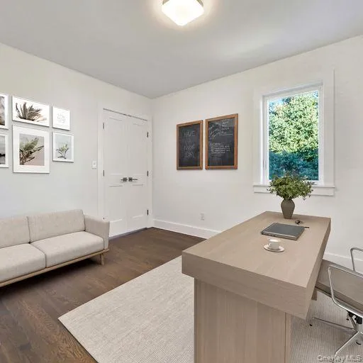 Home office with dark hardwood / wood-style floors Home office with dark hardwood / wood-style floors