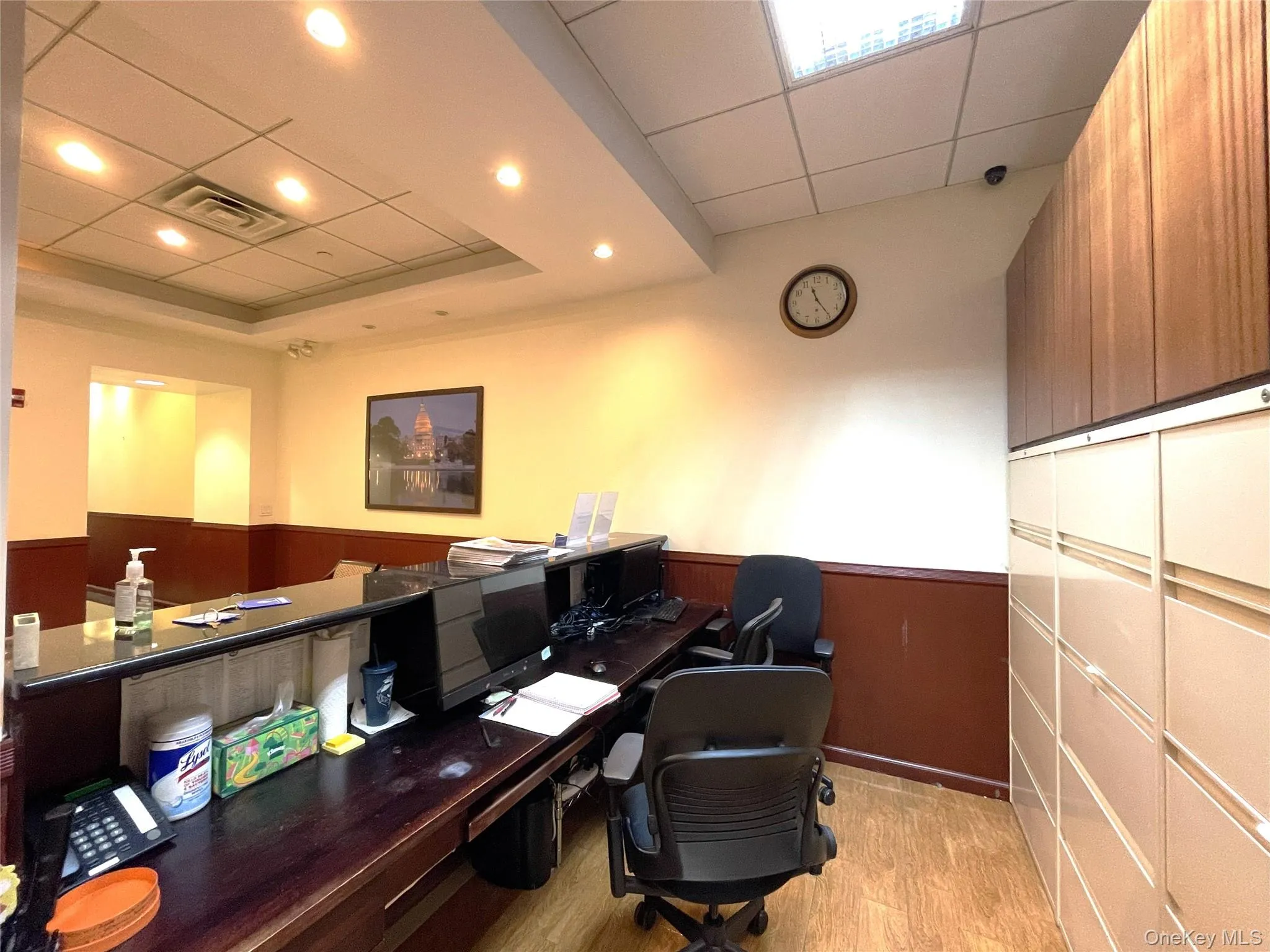 Office space featuring a paneled ceiling, a wainscoted wall, and recessed lighting Office space featuring a paneled ceiling, a wainscoted wall, and recessed lighting