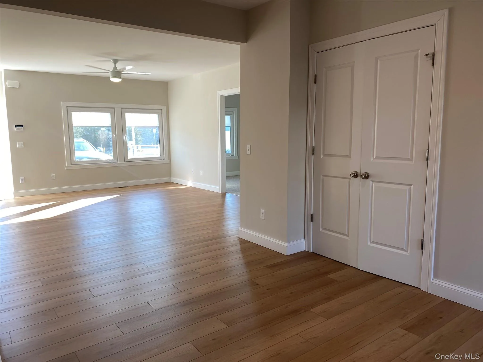 Empty room featuring wood finished floors and a ceiling fan Empty room featuring wood finished floors and a ceiling fan