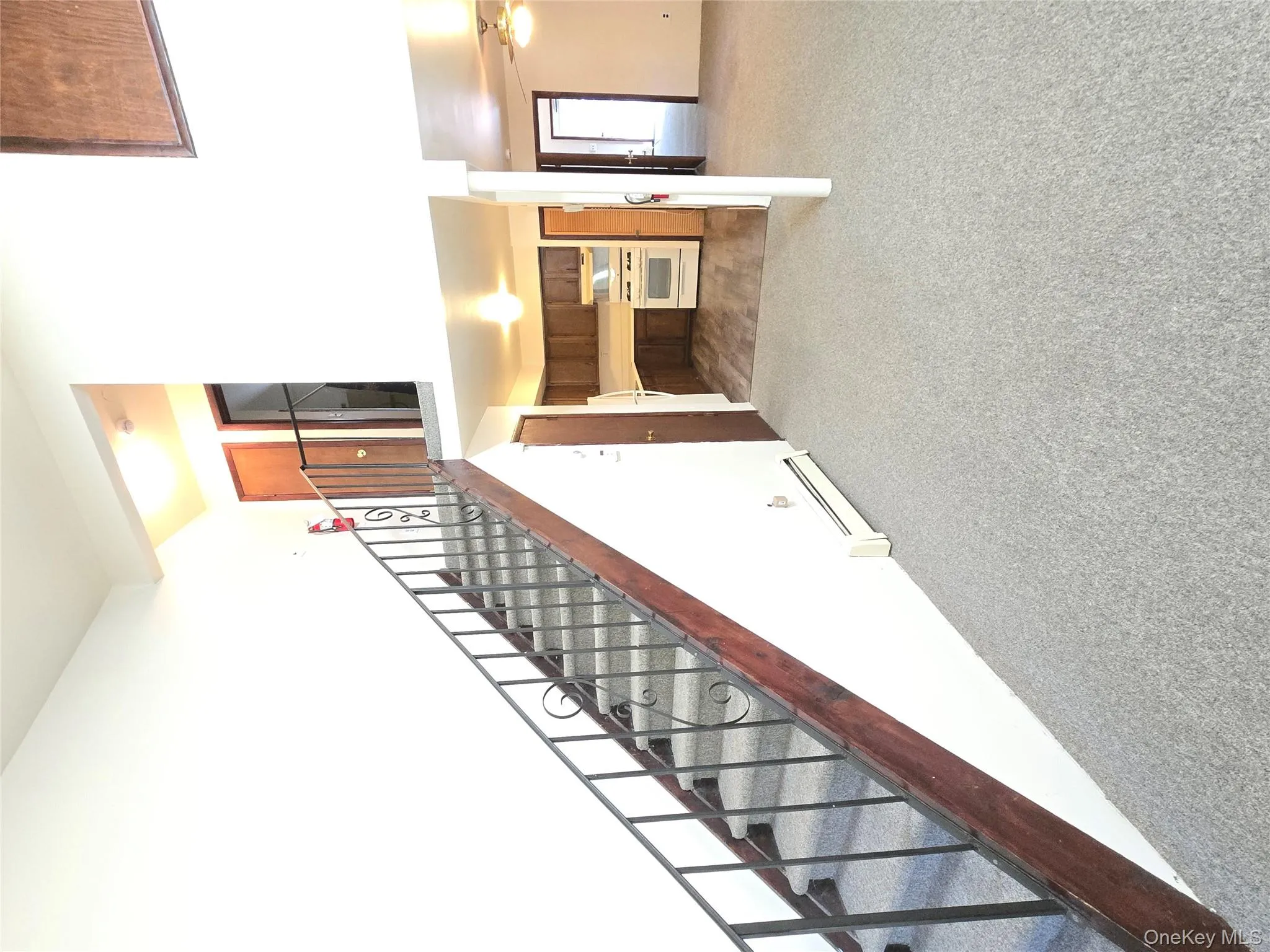 Stairway featuring carpet flooring, baseboard heating, and ceiling fan Stairway featuring carpet flooring, baseboard heating, and ceiling fan