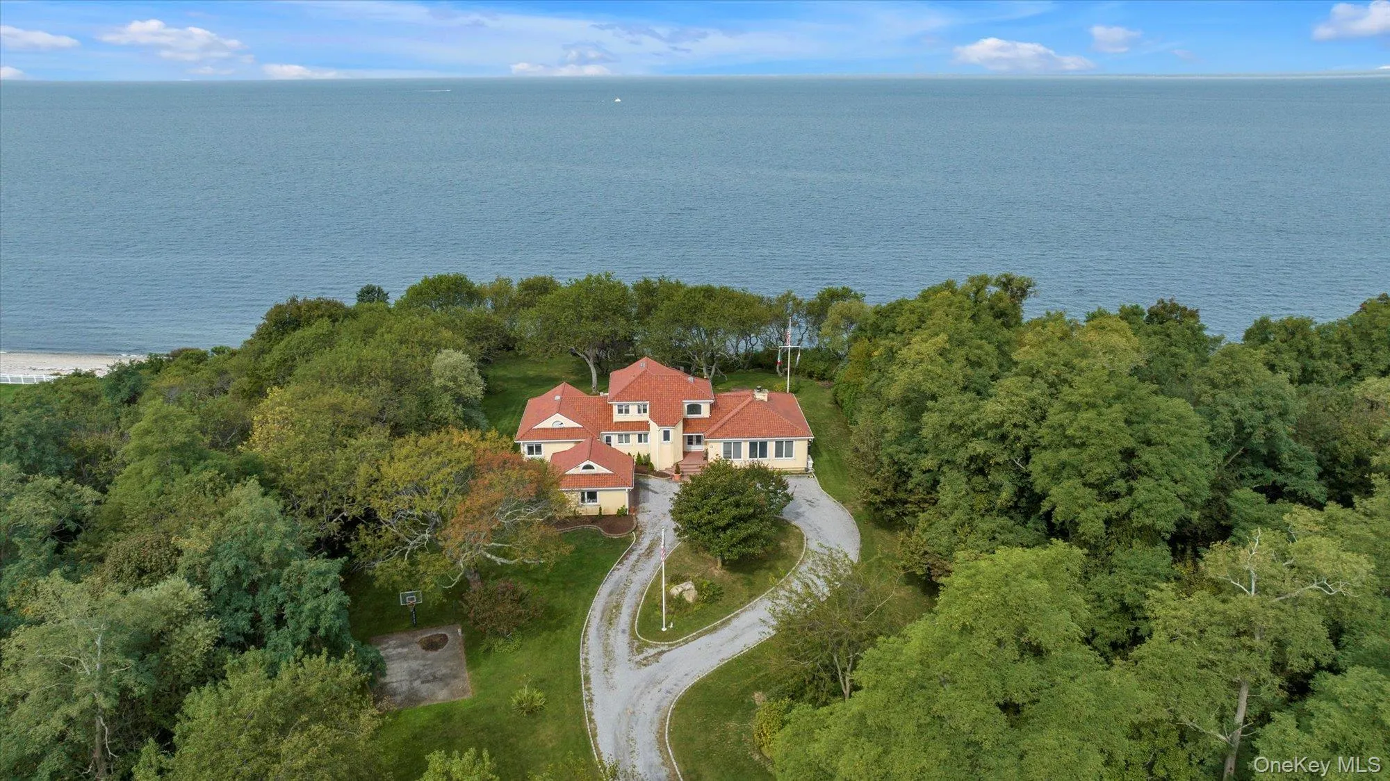 Aerial view of property and surrounding area with a nearby body of water Aerial view of property and surrounding area with a nearby body of water