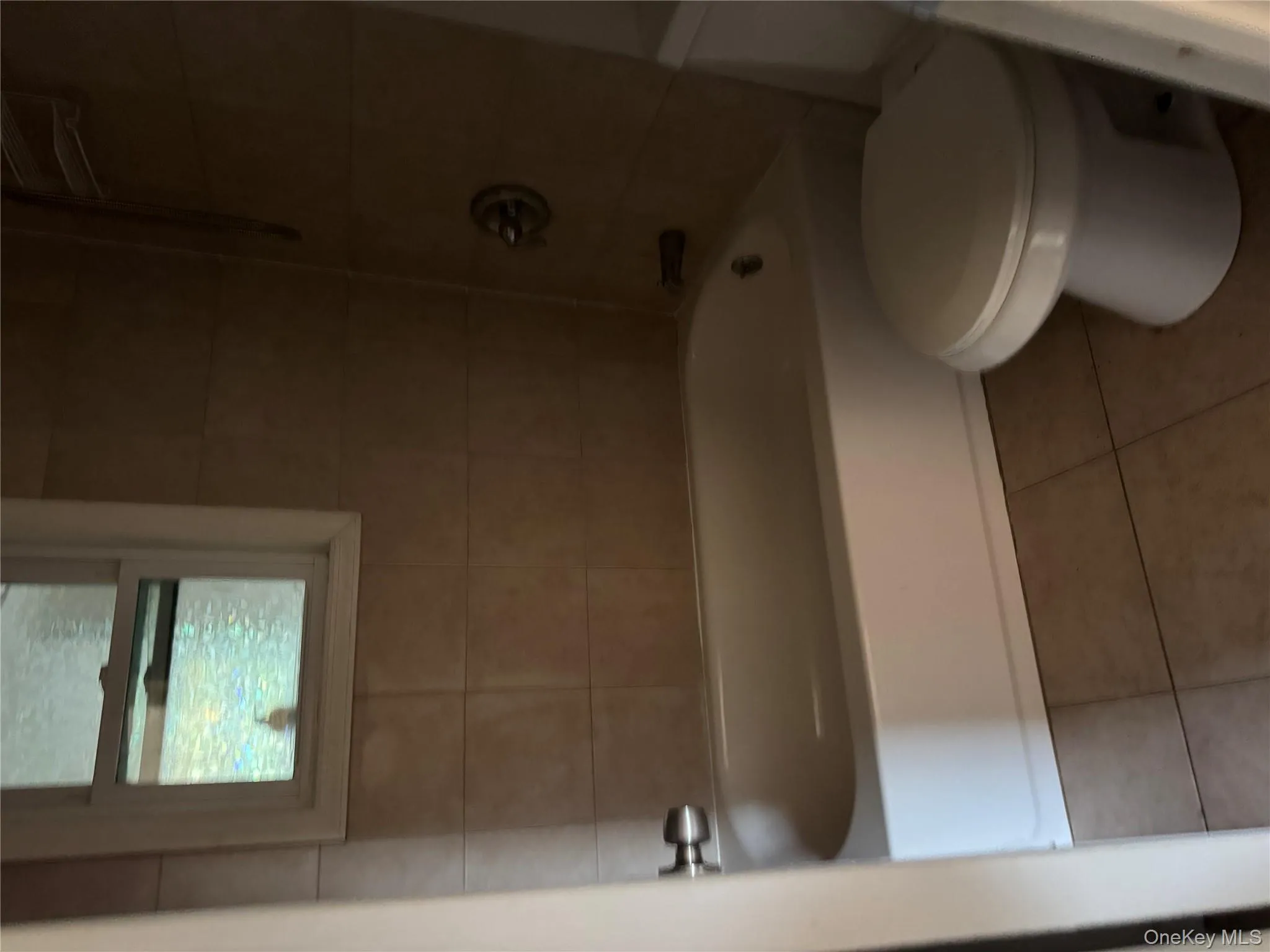 Full bath featuring tile patterned floors and tub / shower combination Full bath featuring tile patterned floors and tub / shower combination