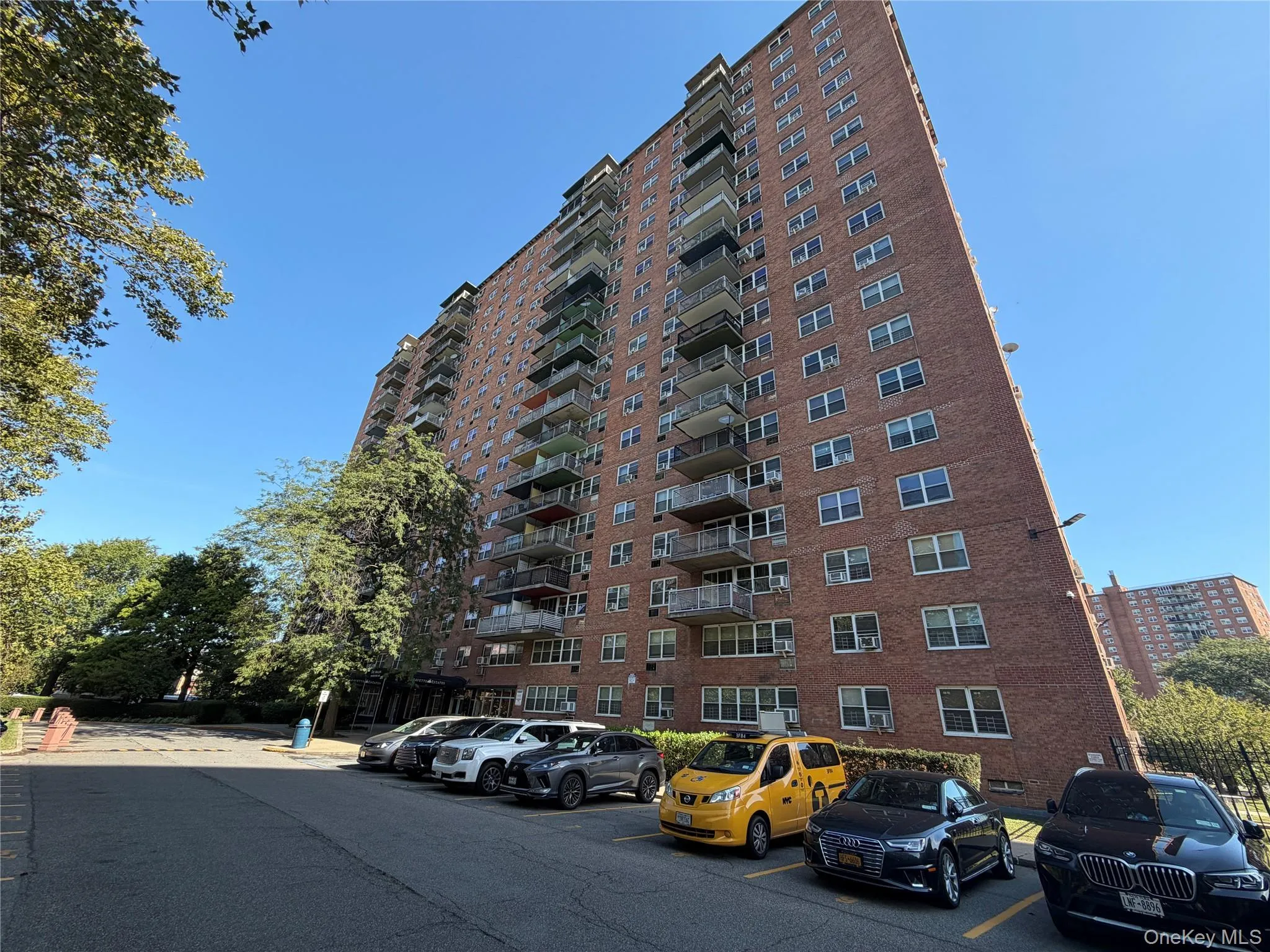 View of apartment building / complex featuring uncovered parking View of apartment building / complex featuring uncovered parking