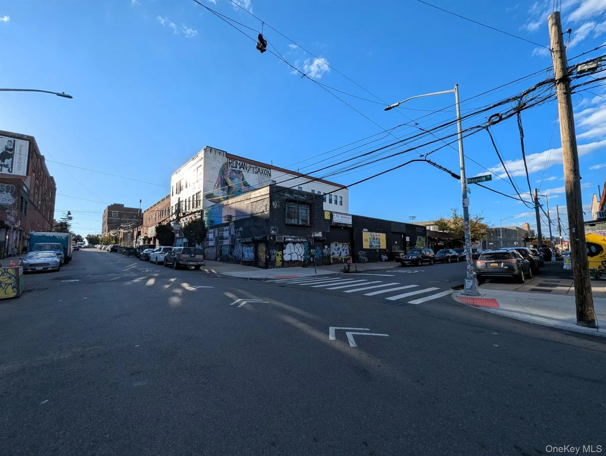 View of asphalt road with sidewalks, street lighting, and curbs View of asphalt road with sidewalks, street lighting, and curbs