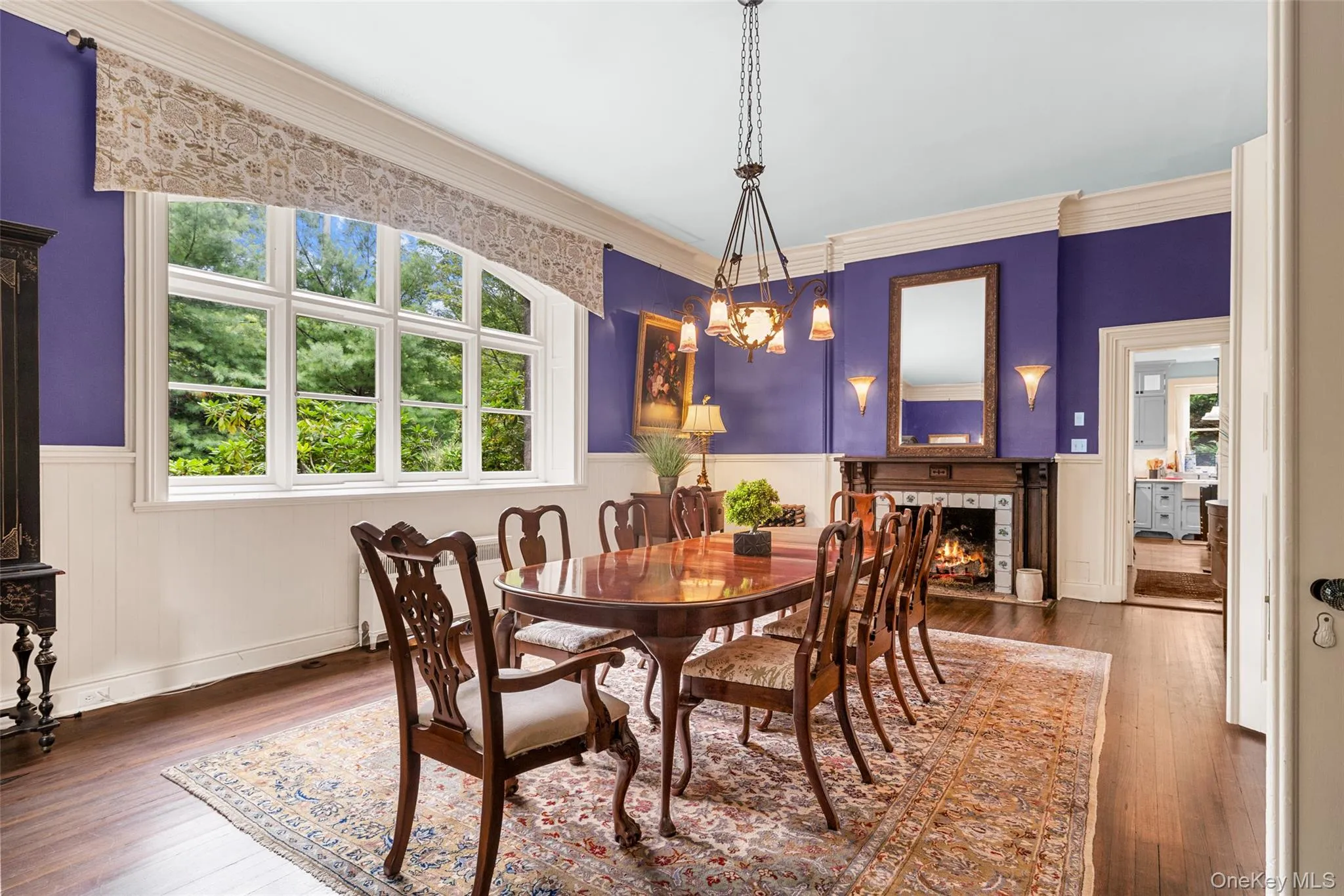 Another view of the formal dining area featuring fireplace and access to butler's pantry Another view of the formal dining area featuring fireplace and access to butler's pantry