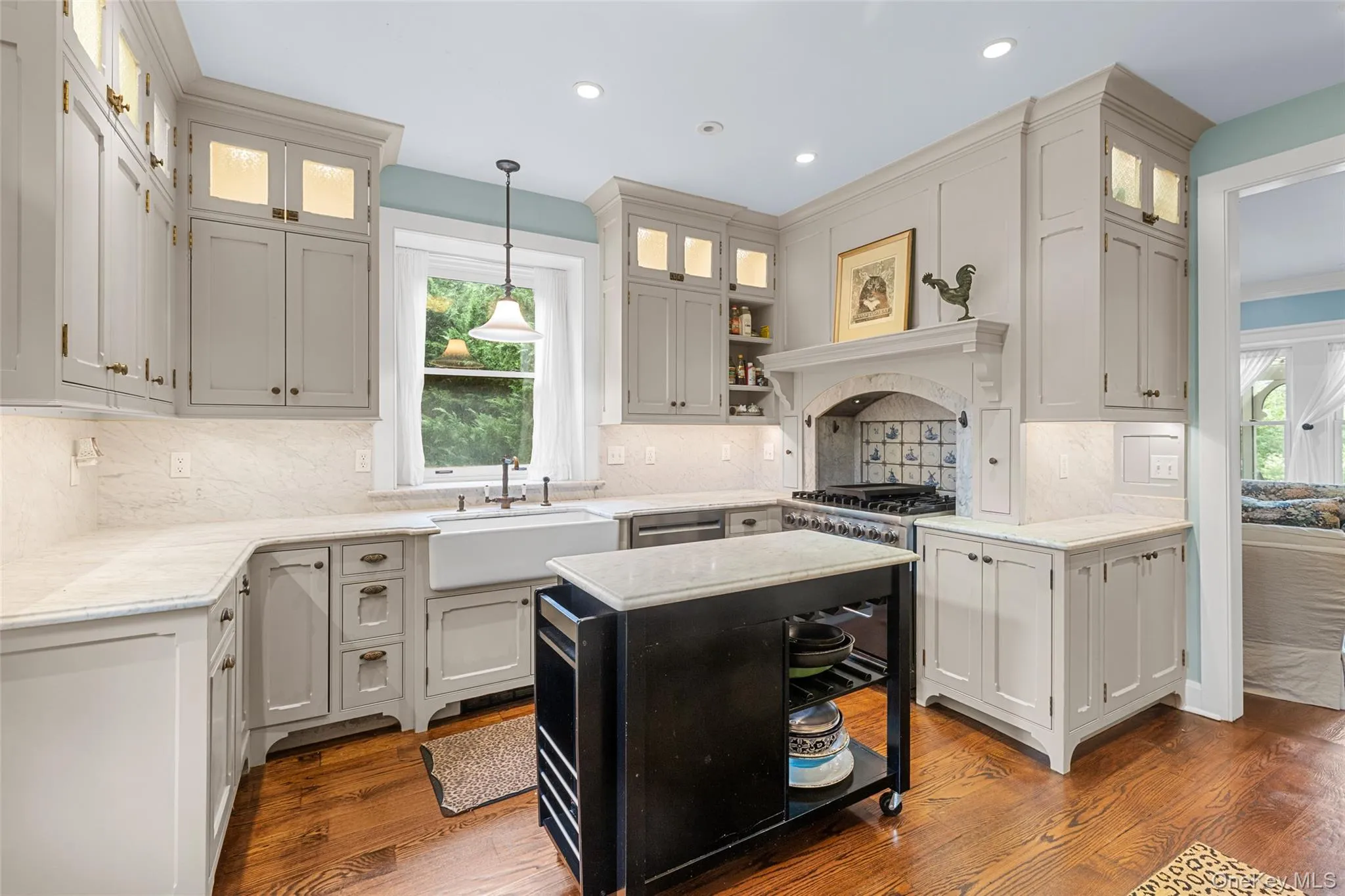 Chef's kitchen with marble counters and delft tile accent Chef's kitchen with marble counters and delft tile accent