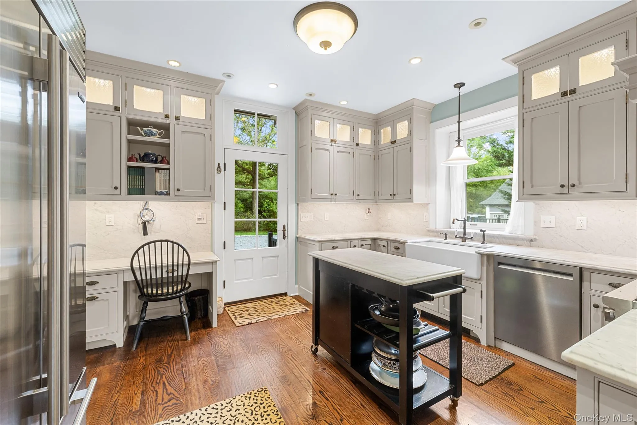 Kitchen features stainless steel appliances, back staircase and access to living room Kitchen features stainless steel appliances, back staircase and access to living room