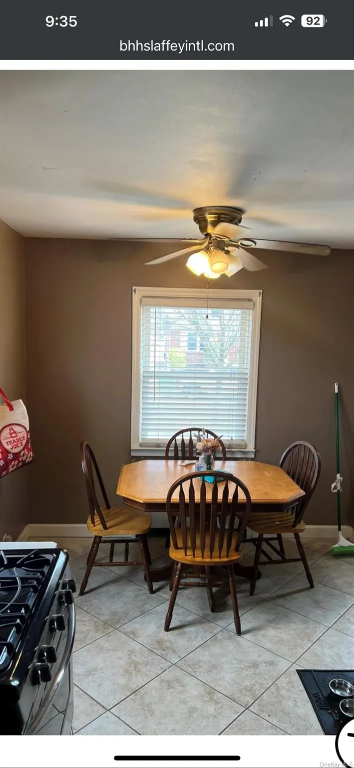 Dining area featuring light tile patterned flooring and ceiling fan Dining area featuring light tile patterned flooring and ceiling fan