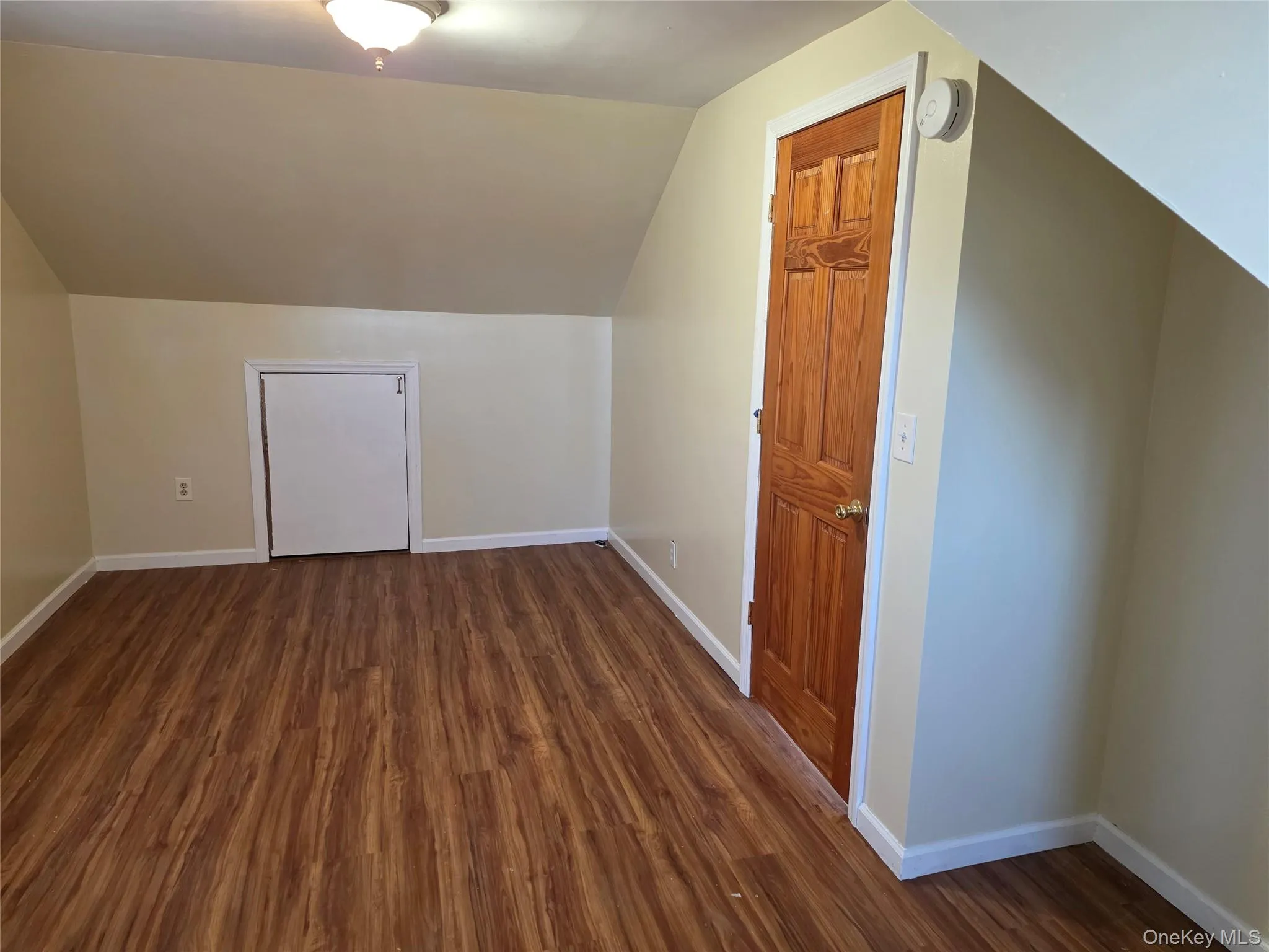 Bedroom - Additional living space with dark wood finished floors and lofted ceiling Bedroom - Additional living space with dark wood finished floors and lofted ceiling