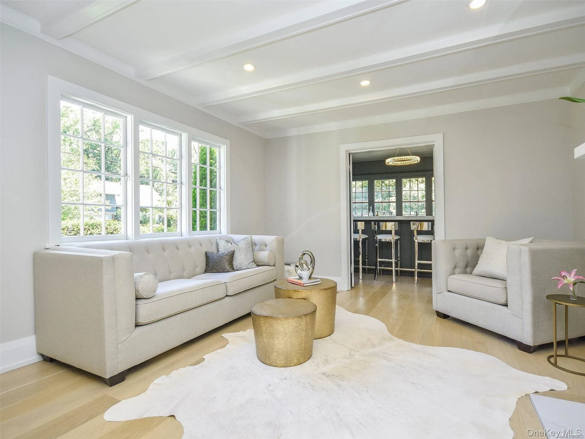 Living room with beamed ceiling, wood finished floors, and recessed lighting Living room with beamed ceiling, wood finished floors, and recessed lighting