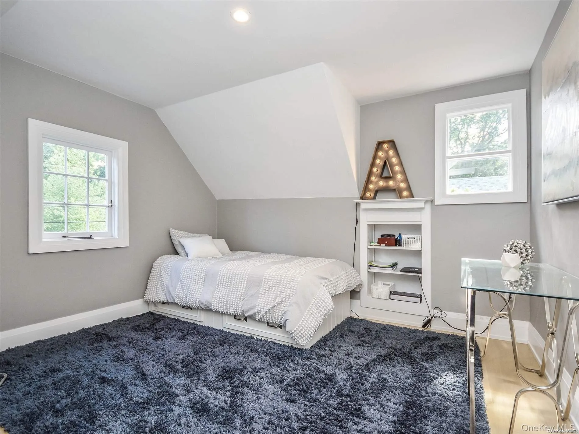Bedroom with vaulted ceiling and carpet flooring Bedroom with vaulted ceiling and carpet flooring