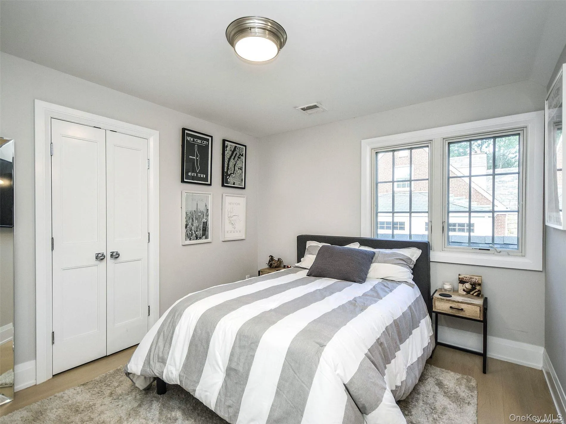 Bedroom featuring light wood-style floors and a closet Bedroom featuring light wood-style floors and a closet