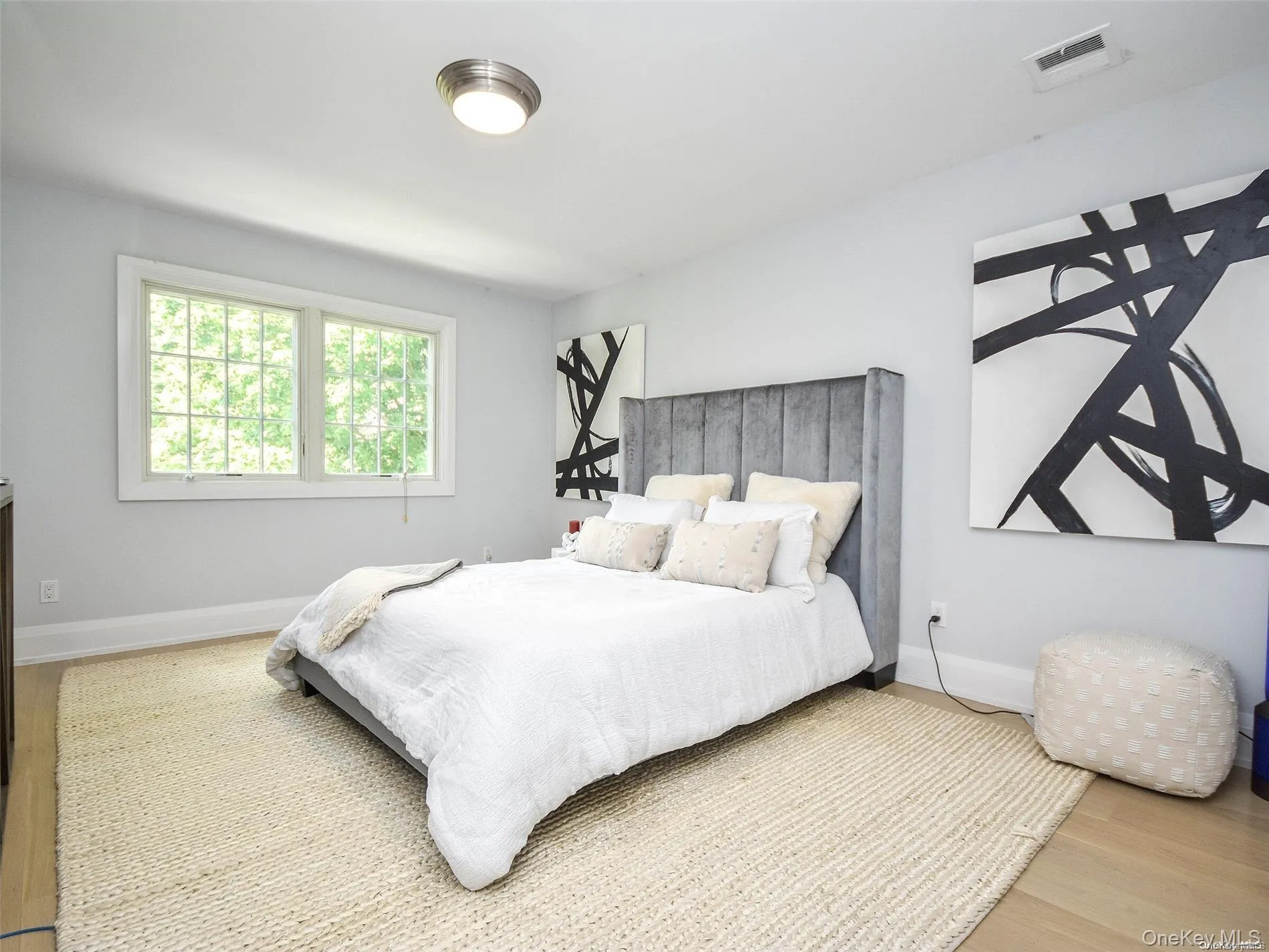 Bedroom featuring wood finished floors and baseboards Bedroom featuring wood finished floors and baseboards