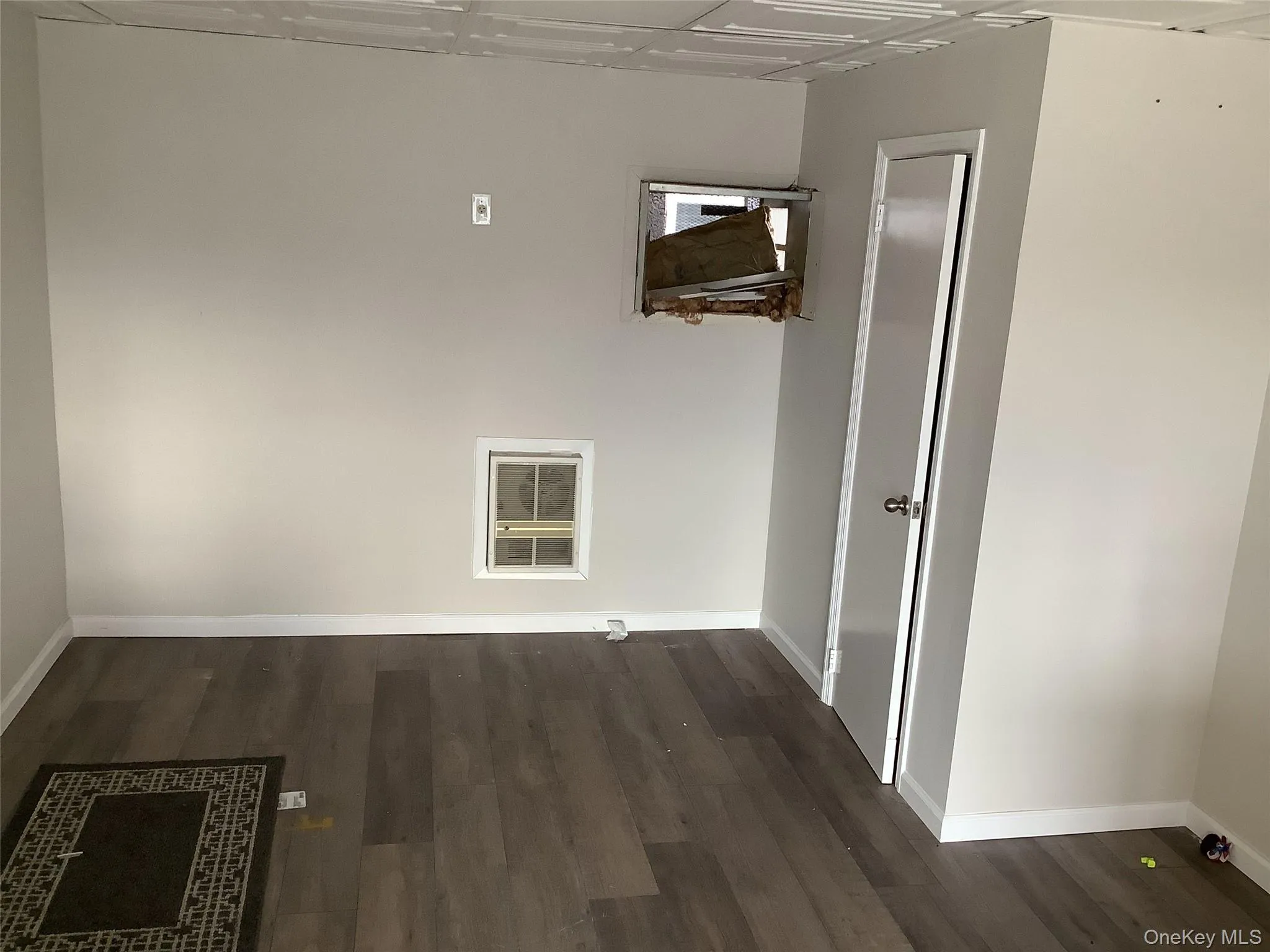 Laundry room with baseboards and dark wood-style floors Laundry room with baseboards and dark wood-style floors